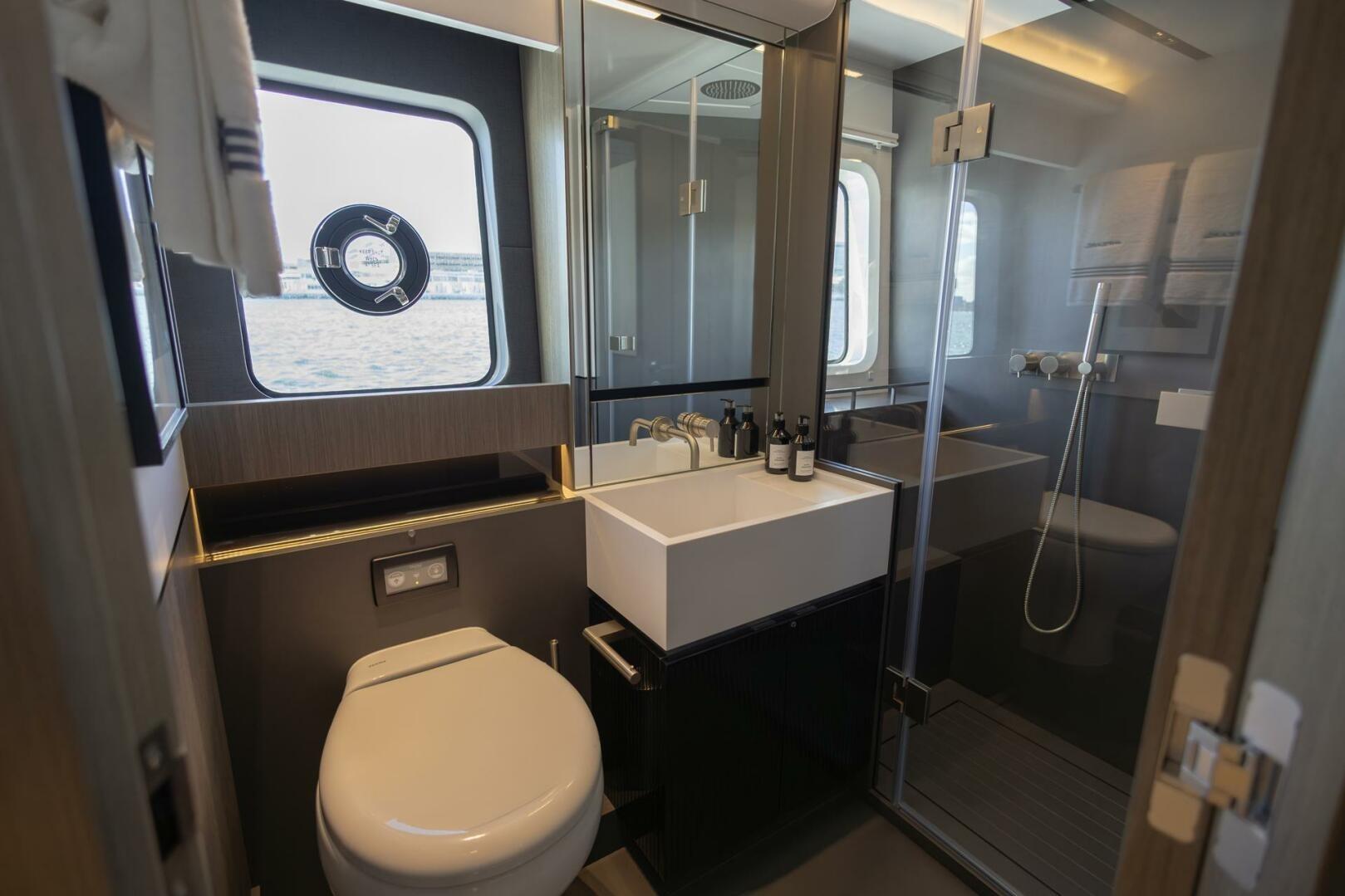 Luxurious bathroom on 2023 Pearl 72 yacht with modern fixtures and ocean view.
