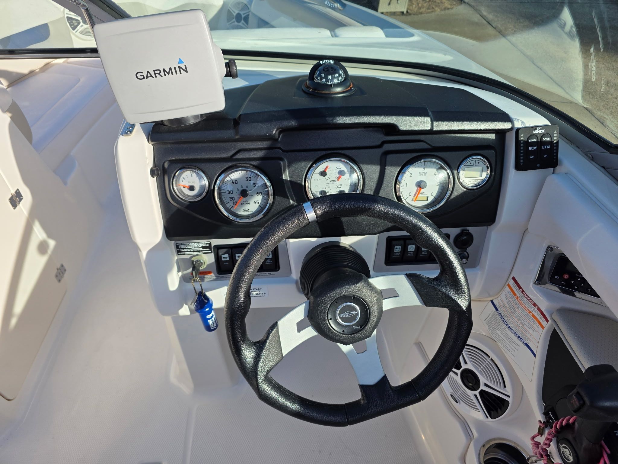 The cockpit of a Chaparral 206 SSi boat with steering wheel and instrument panel.