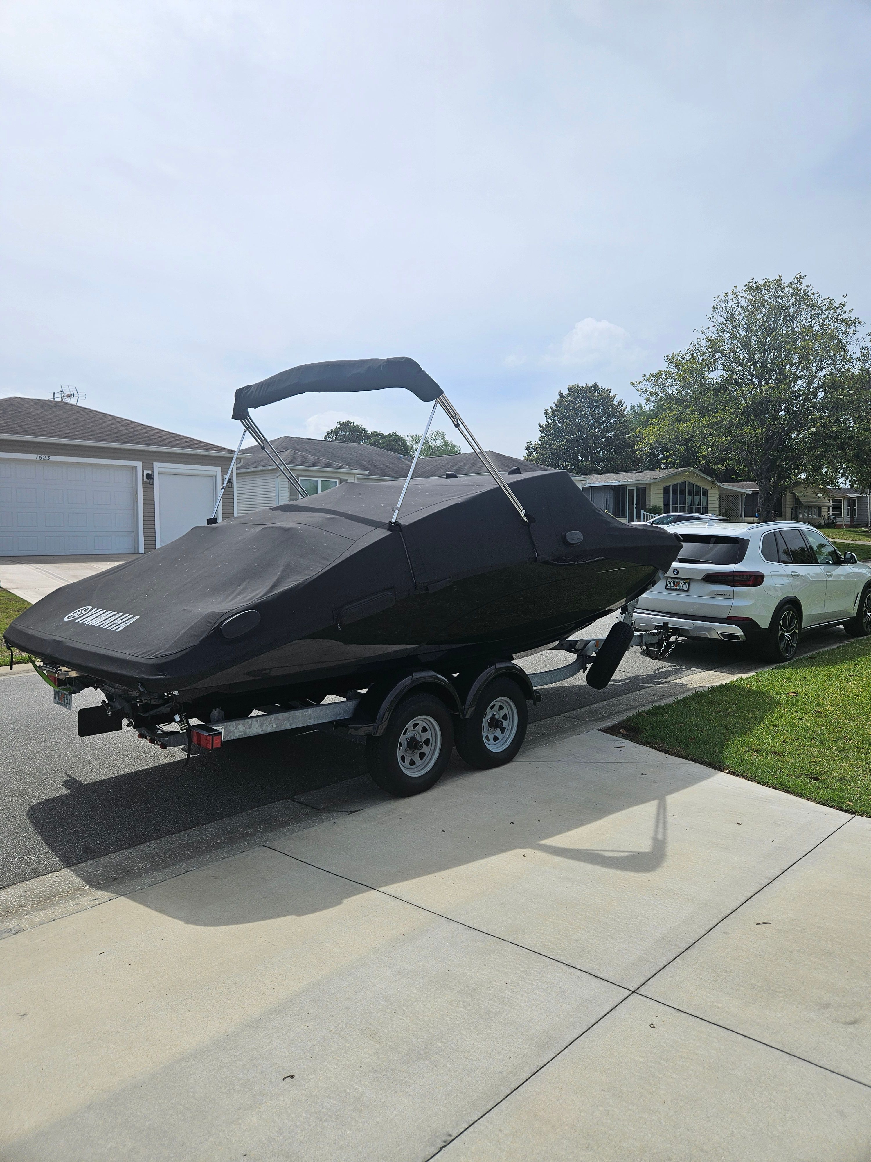 2022 Yamaha SX210 boat on trailer in residential area.