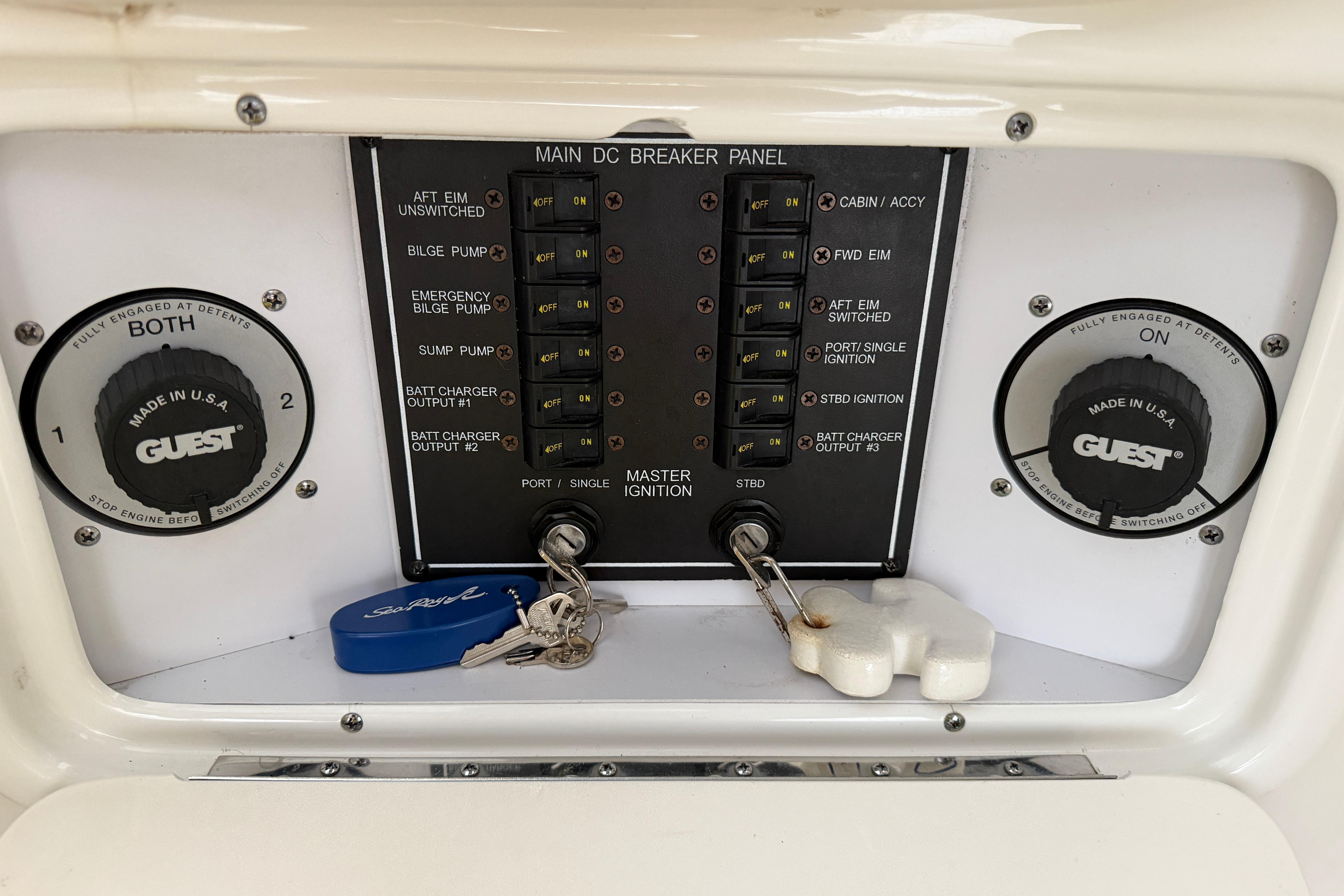 Control panel of a 2003 Sea Ray 290 Bowrider boat with ignition keys.