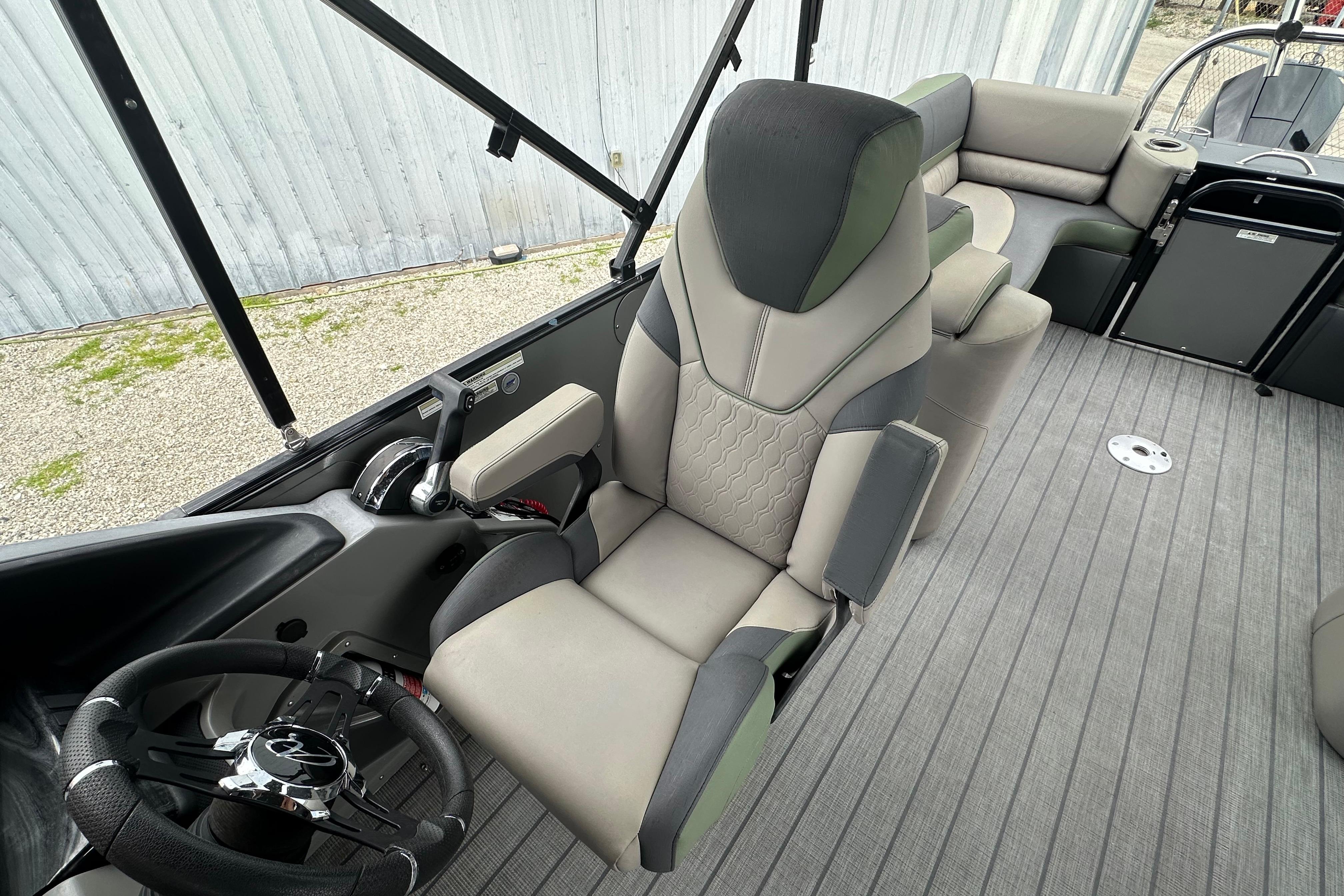 2023 Avalon Catalina Quad Lounge interior with captain's chair and steering wheel.