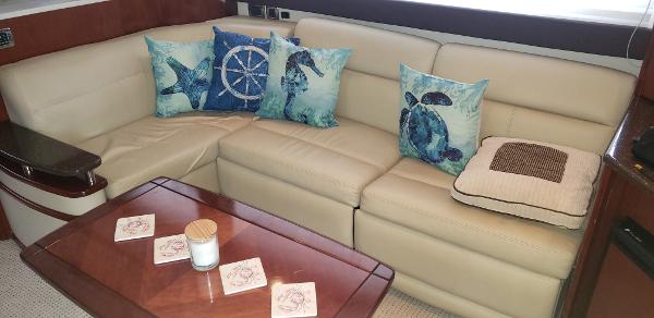 Luxurious Meridian 441 Sedan 2010 interior with beige leather seating and nautical-themed pillows.