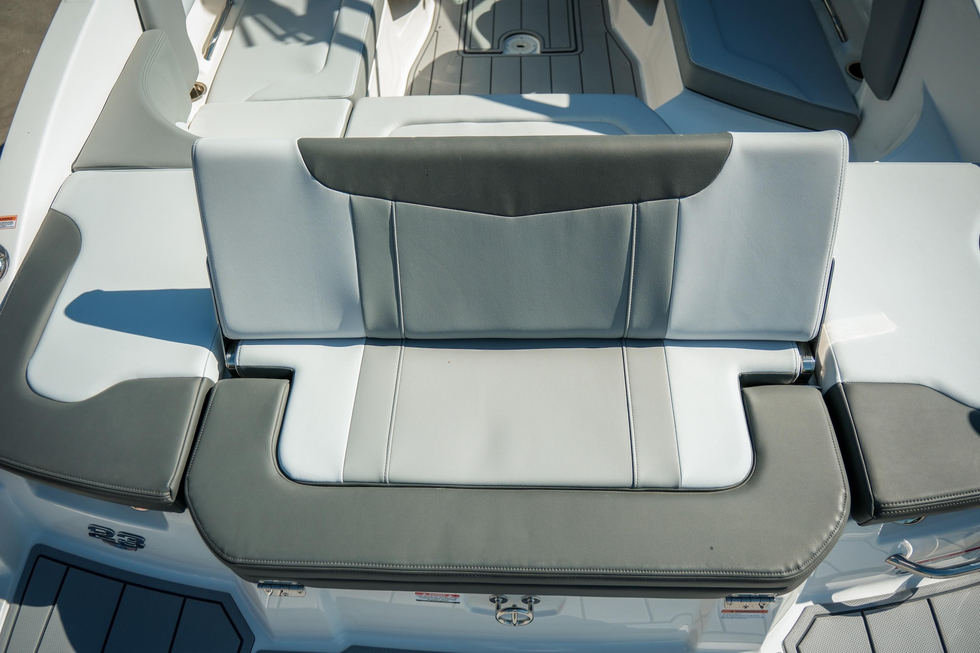 2026 Chaparral 23 SSi boat interior with gray and white cushioned seating.