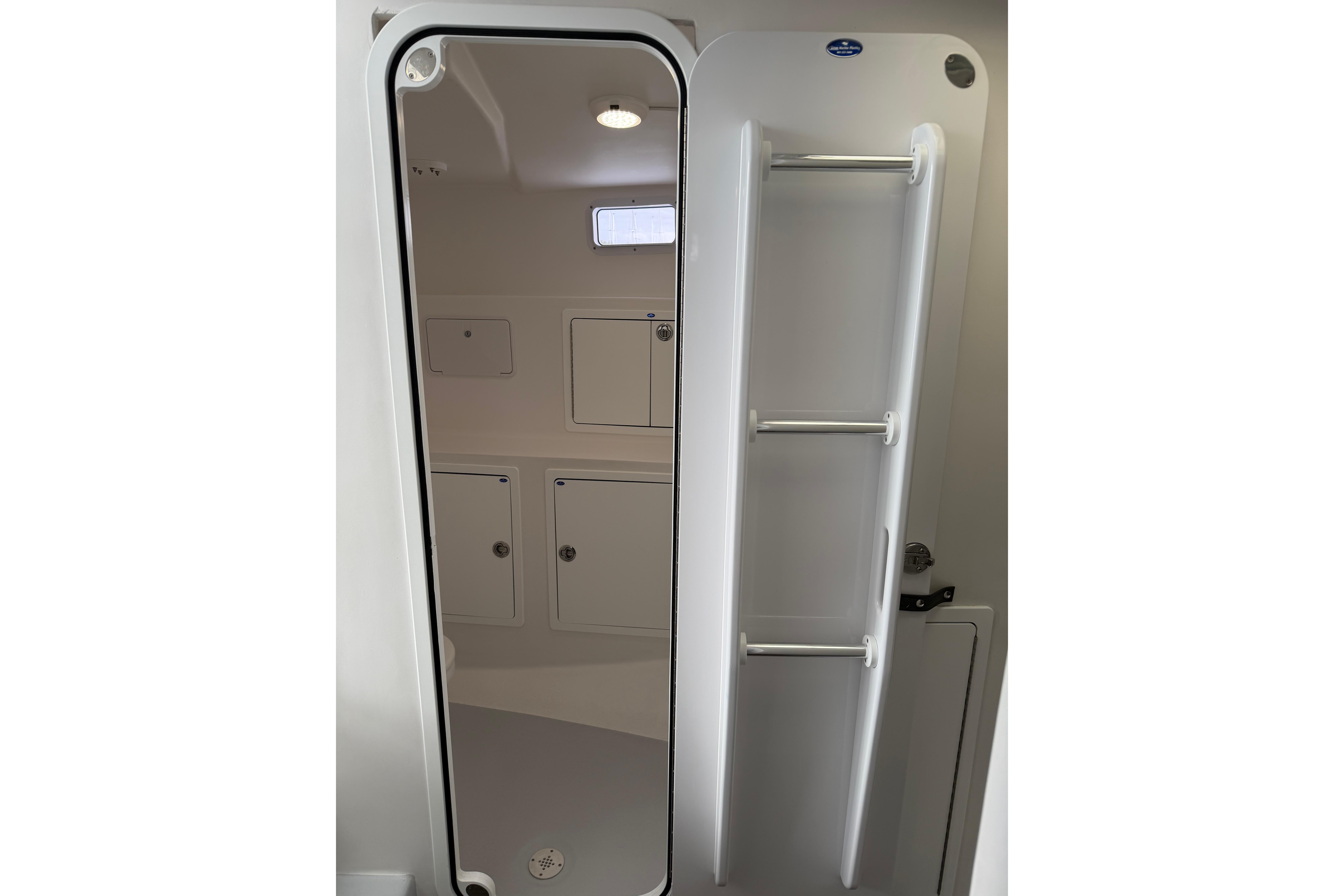 Interior of 2018 H&H Marine Osmond Beal boat, featuring storage compartments and sleek design.