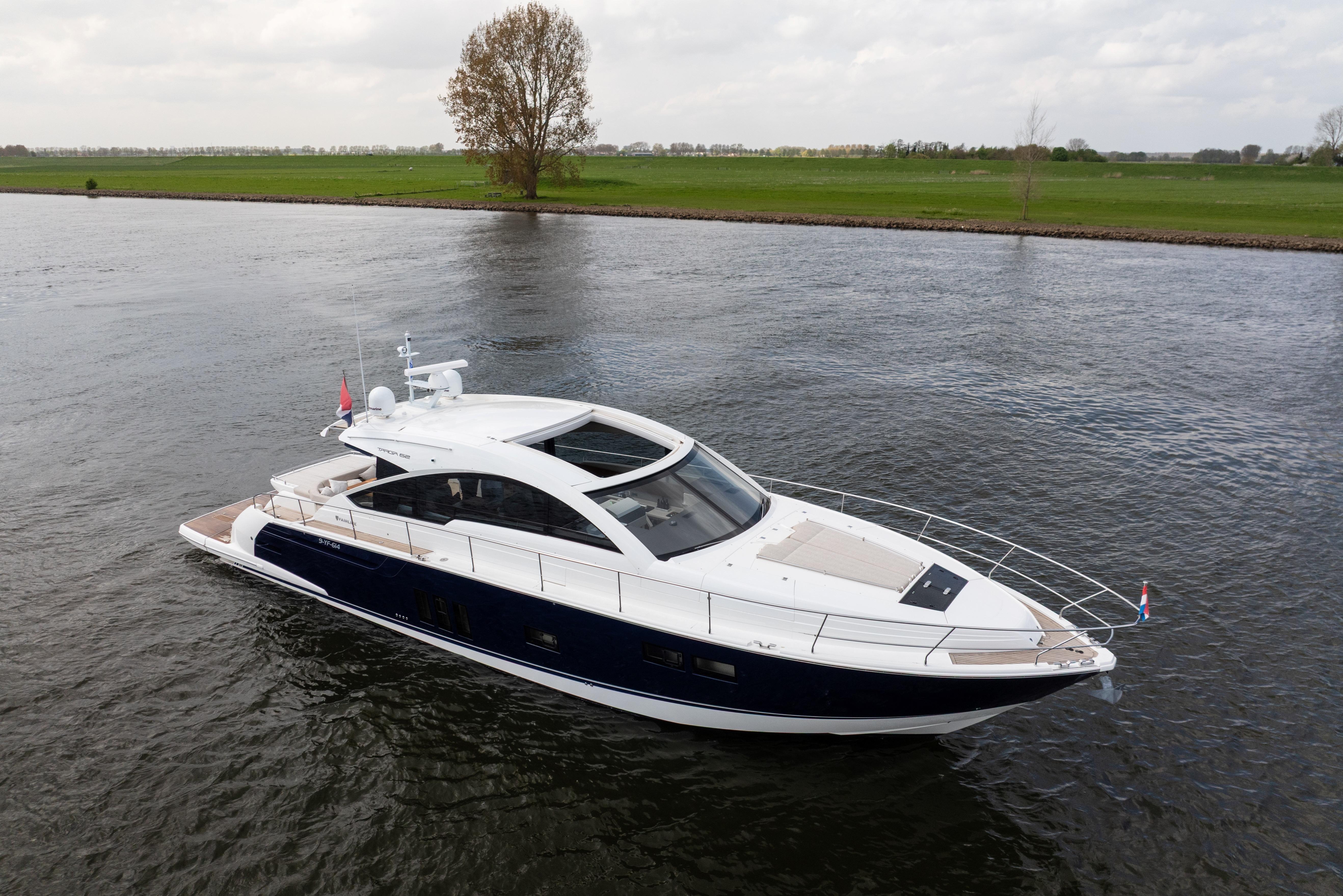 Luxury 2015 Fairline Targa 62 GT yacht cruising on a serene river.