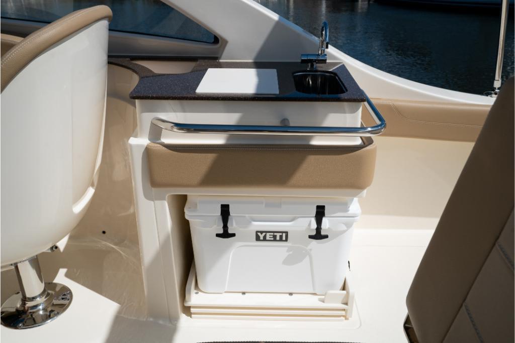 2023 Scout 240 Dorado boat interior with sink and Yeti cooler.