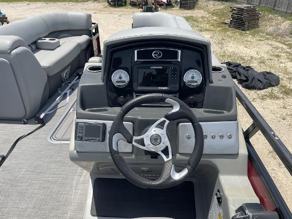 2023 Regency 250 DL3 boat dashboard with steering wheel and control panel.