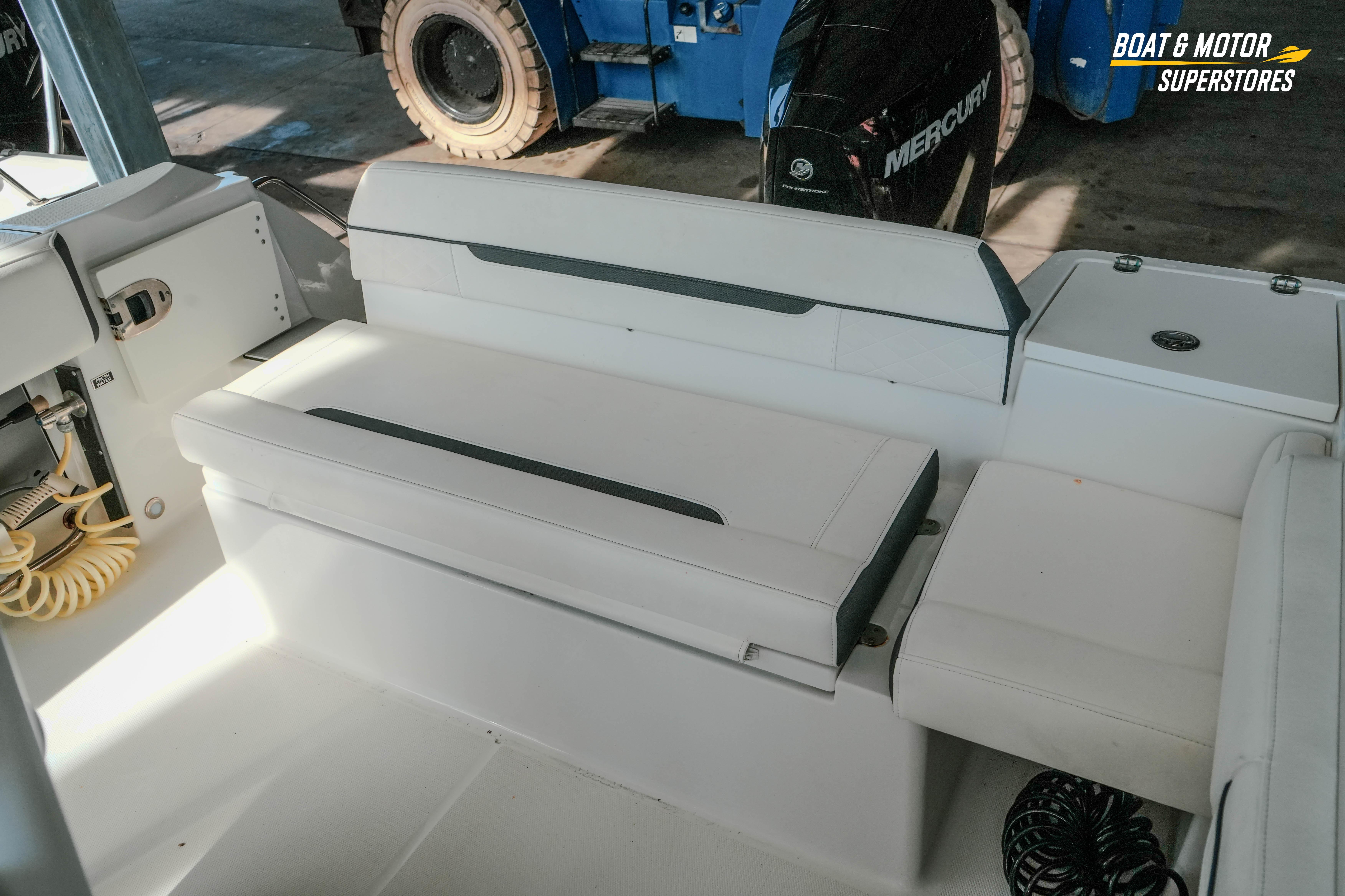 2022 Blackfin 222 CC boat interior with white seating and Mercury engine.