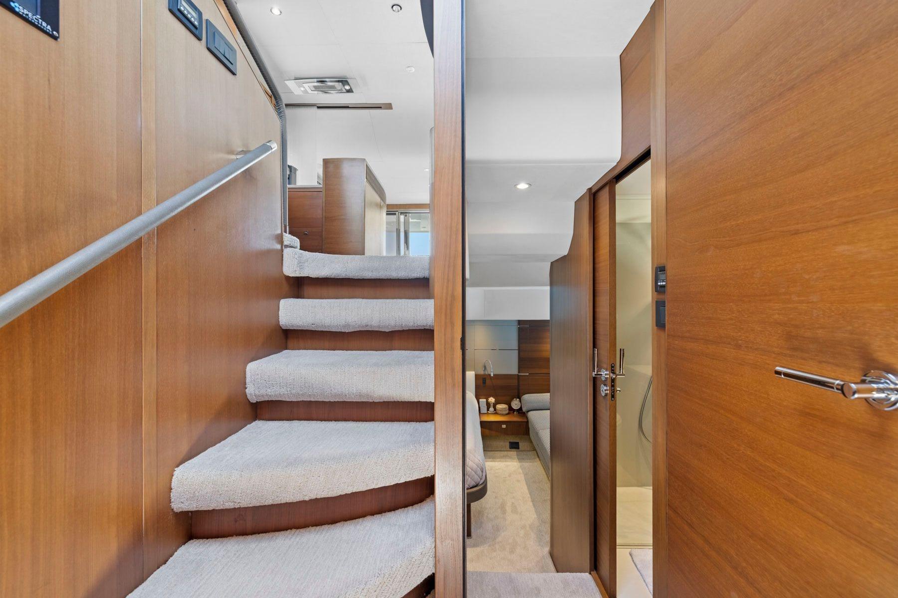 Interior of 2015 Princess 60 Flybridge Yacht with wooden stairs and modern design.