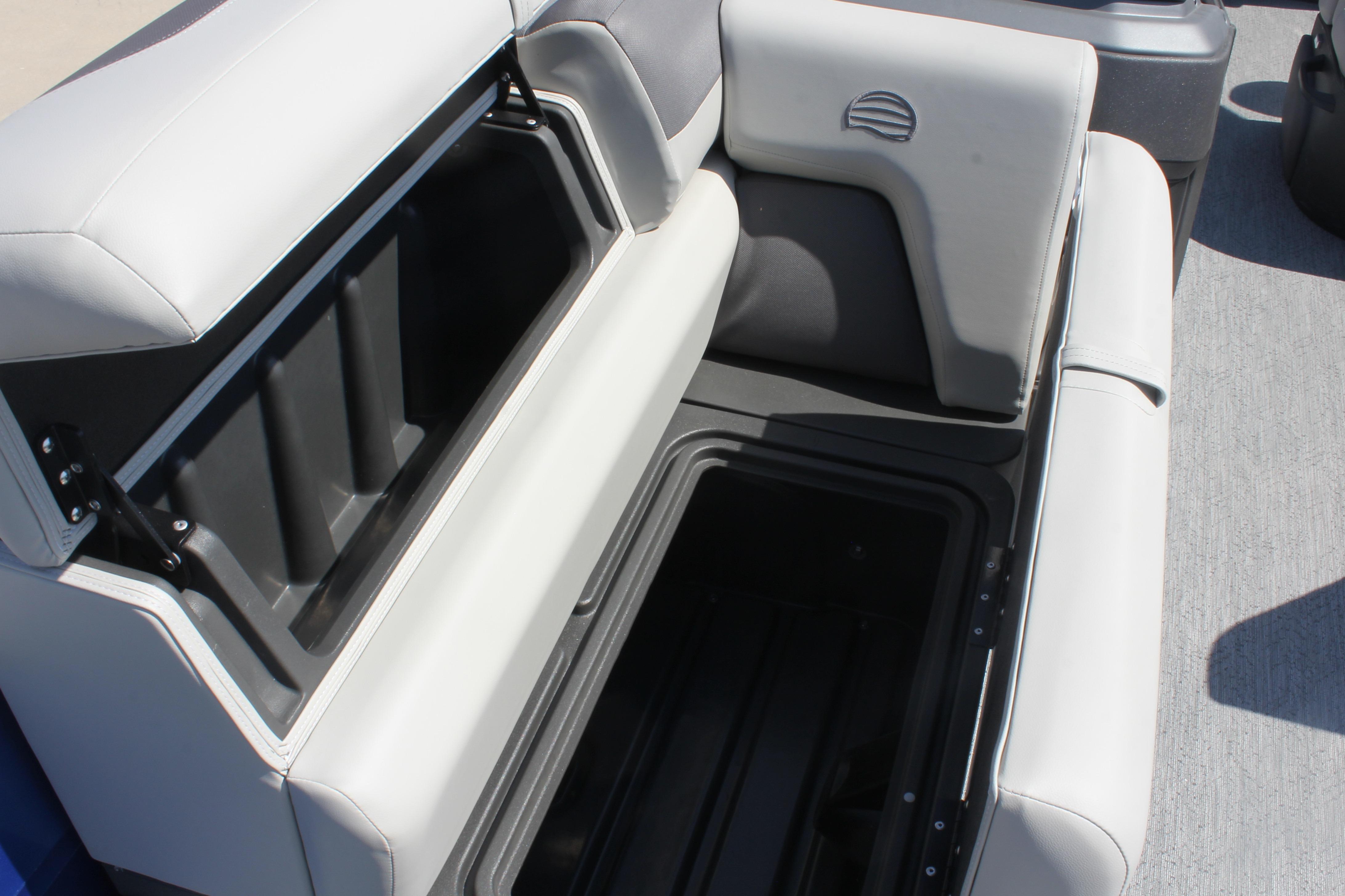 Open storage compartment on 2026 Sun Tracker Fishin' Barge 20 DLX boat seat.