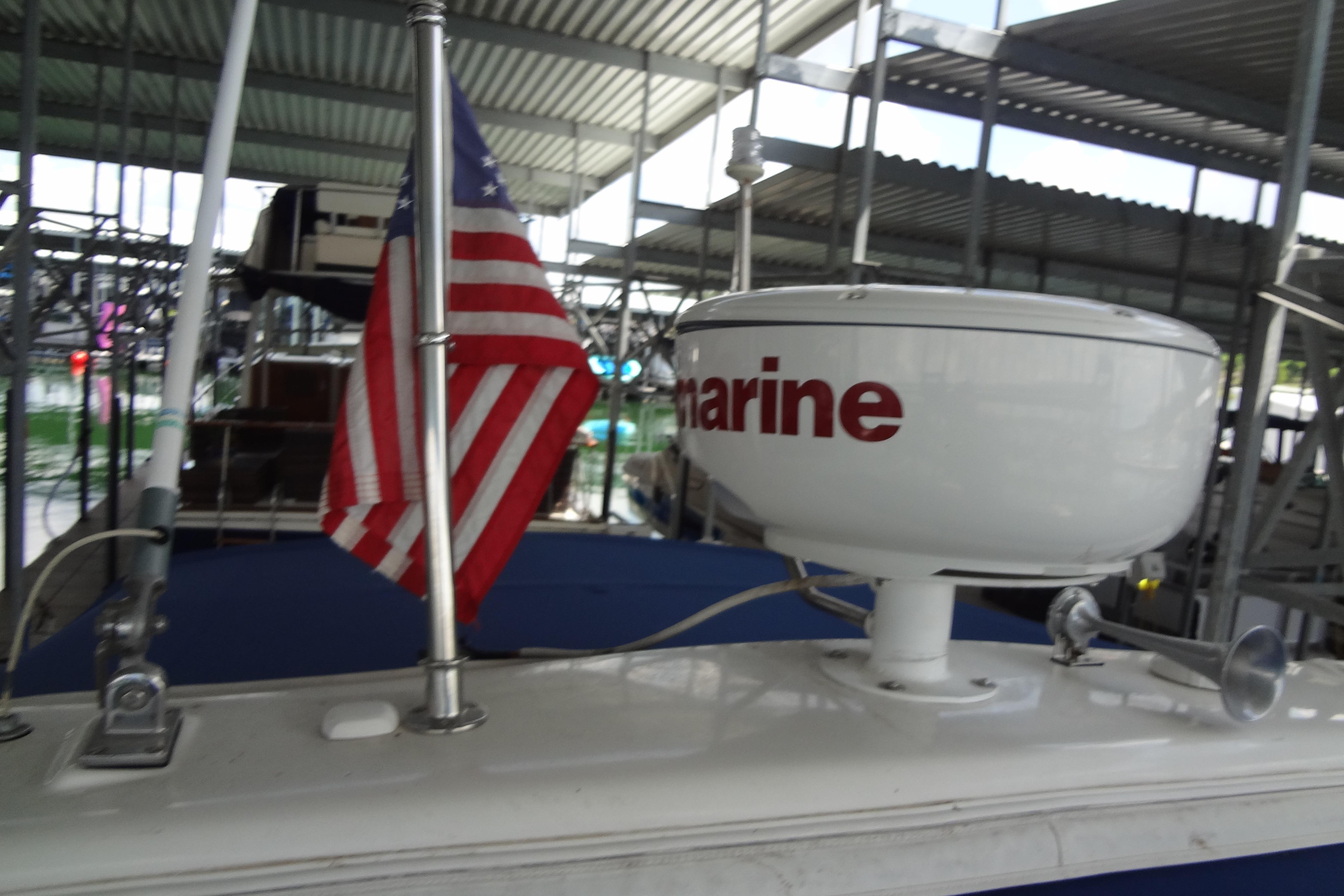 2007 Formula 34 Performance Cruiser with radar and American flag in marina.