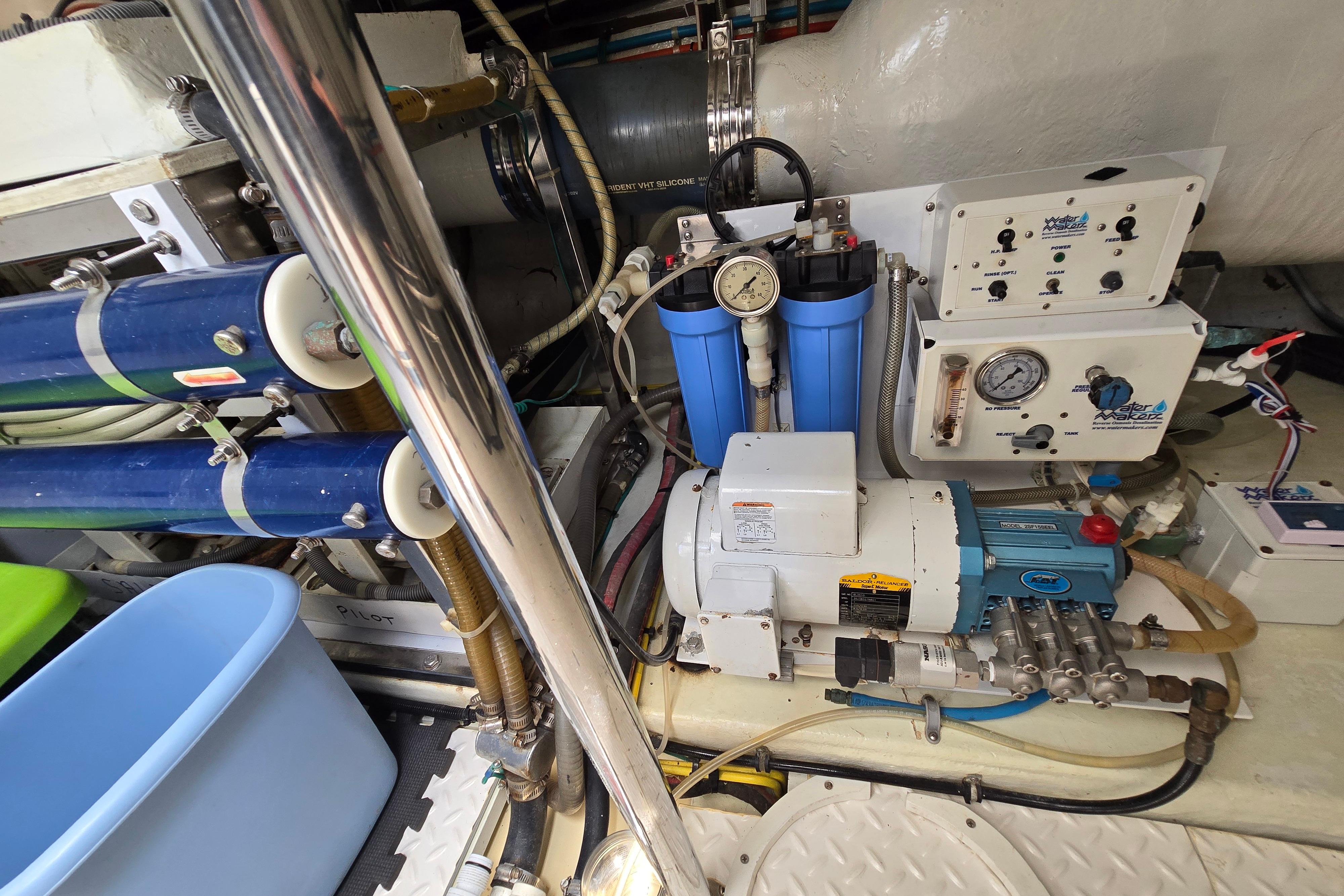 Engine room of 2004 Grand Harbour 58 yacht with water filtration system and gauges.