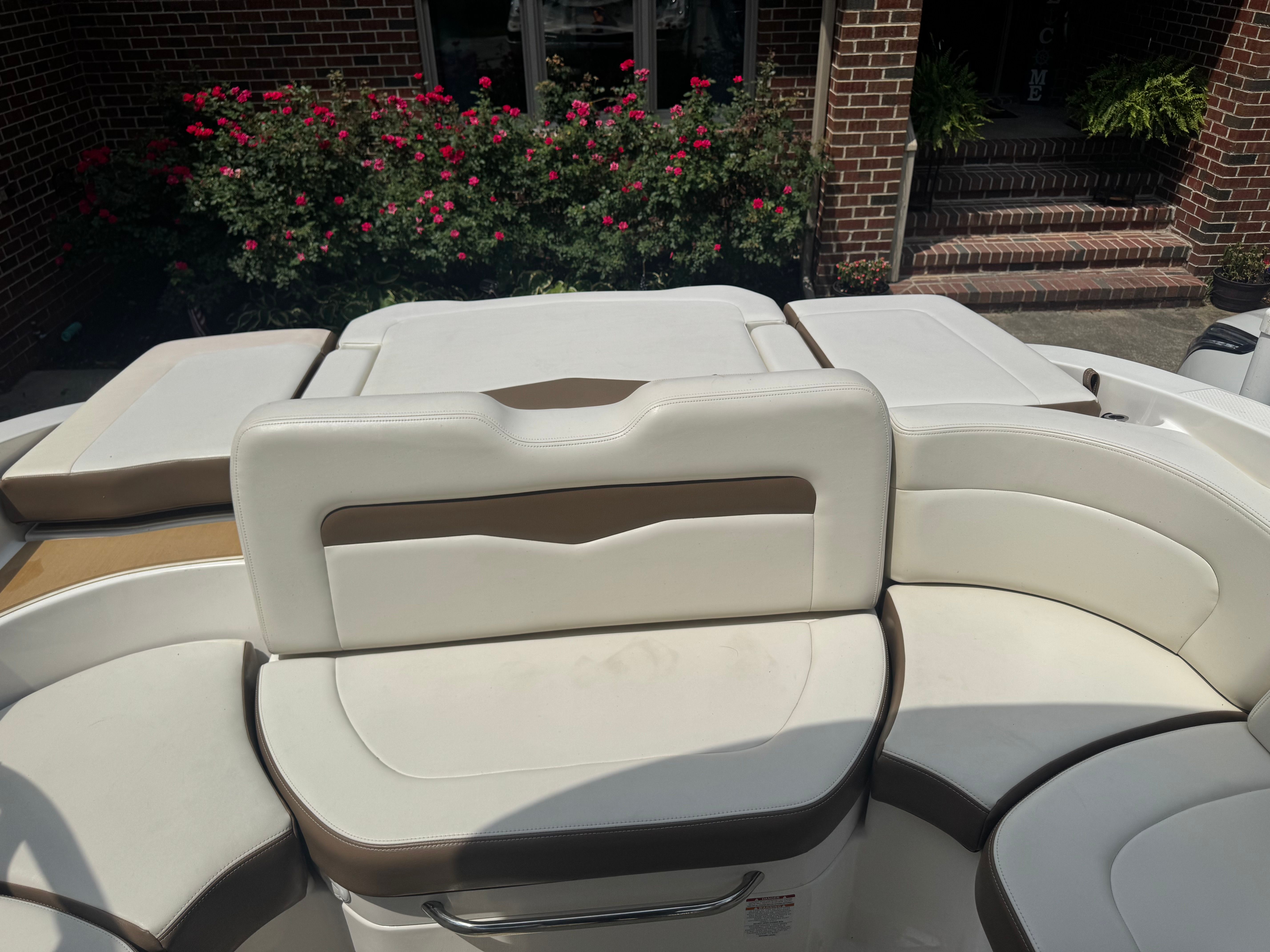 Interior of a 2016 Chaparral 246 SSi boat with white seating.