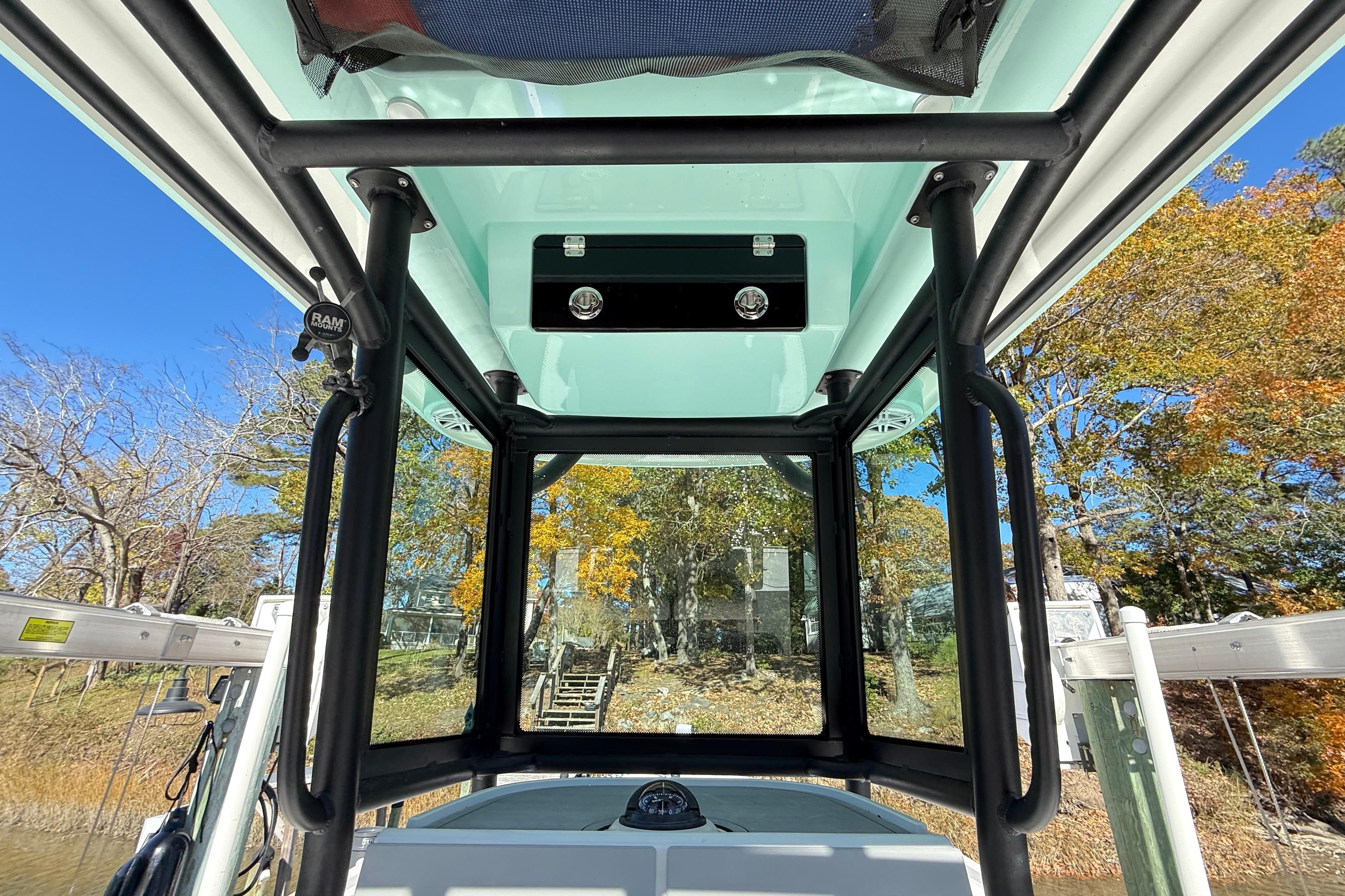 Interior view of 2023 Caymas 281 HB boat with clear canopy and scenic background.