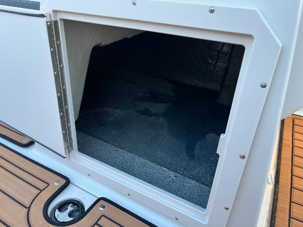 2024 Starcraft SVX 191 storage compartment with teak flooring.