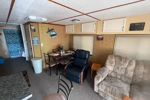 Interior of a 1995 Myacht 40X13 houseboat with cozy seating and dining area.