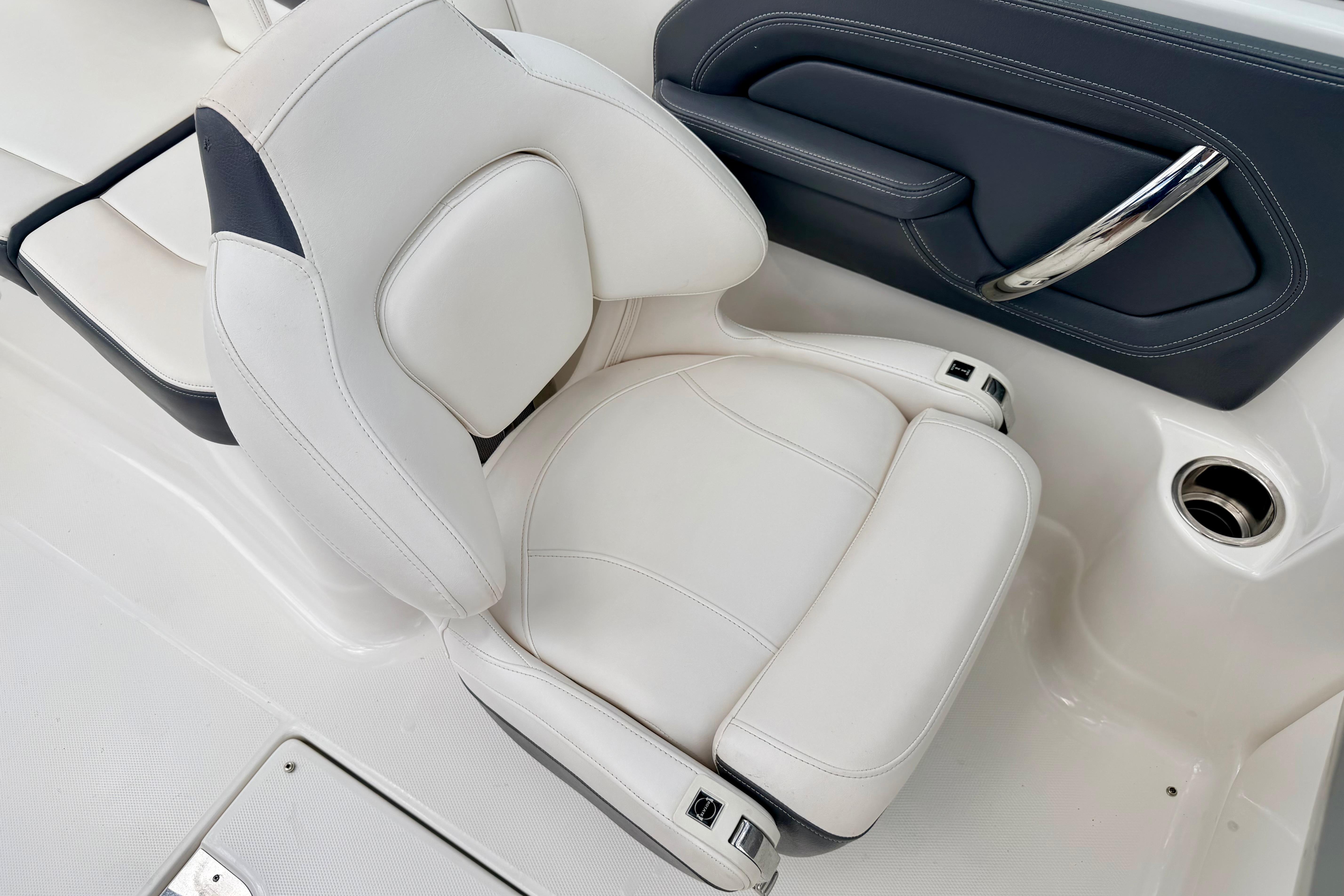 2015 Chaparral Sunesta 264 boat seat, featuring white upholstery and sleek design.