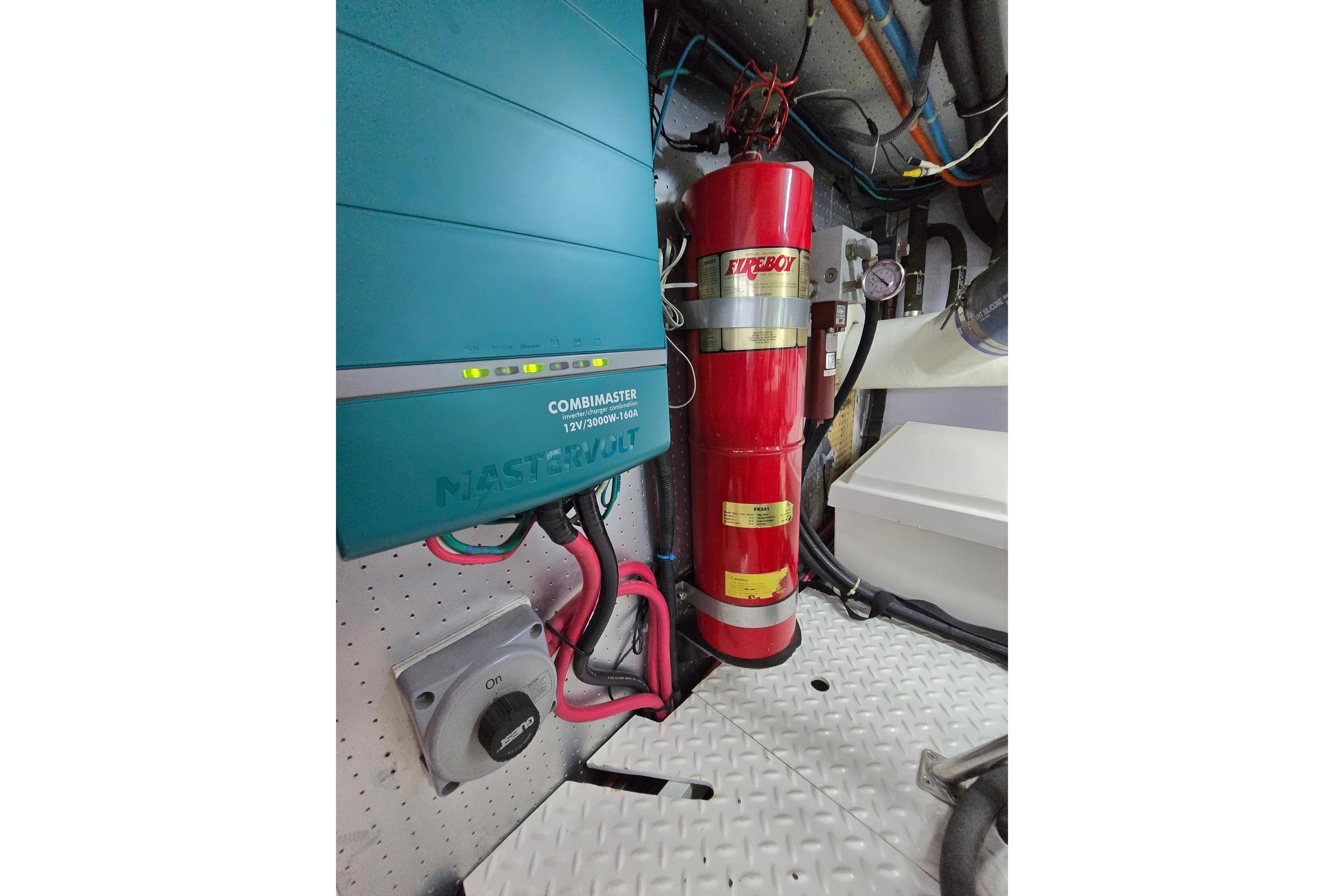 Engine room of 2004 Grand Harbour 58 with fire extinguisher and electrical components.