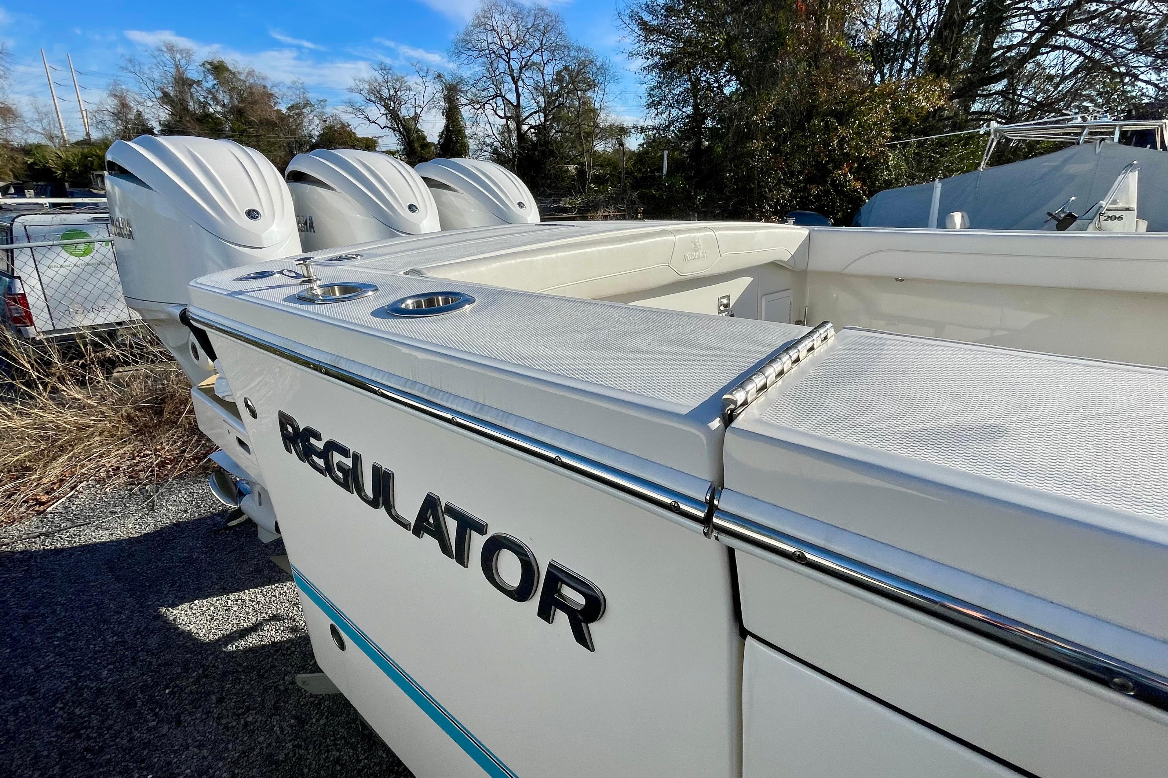 2023 Regulator 34 boat with triple engines, sleek design, and spacious deck.