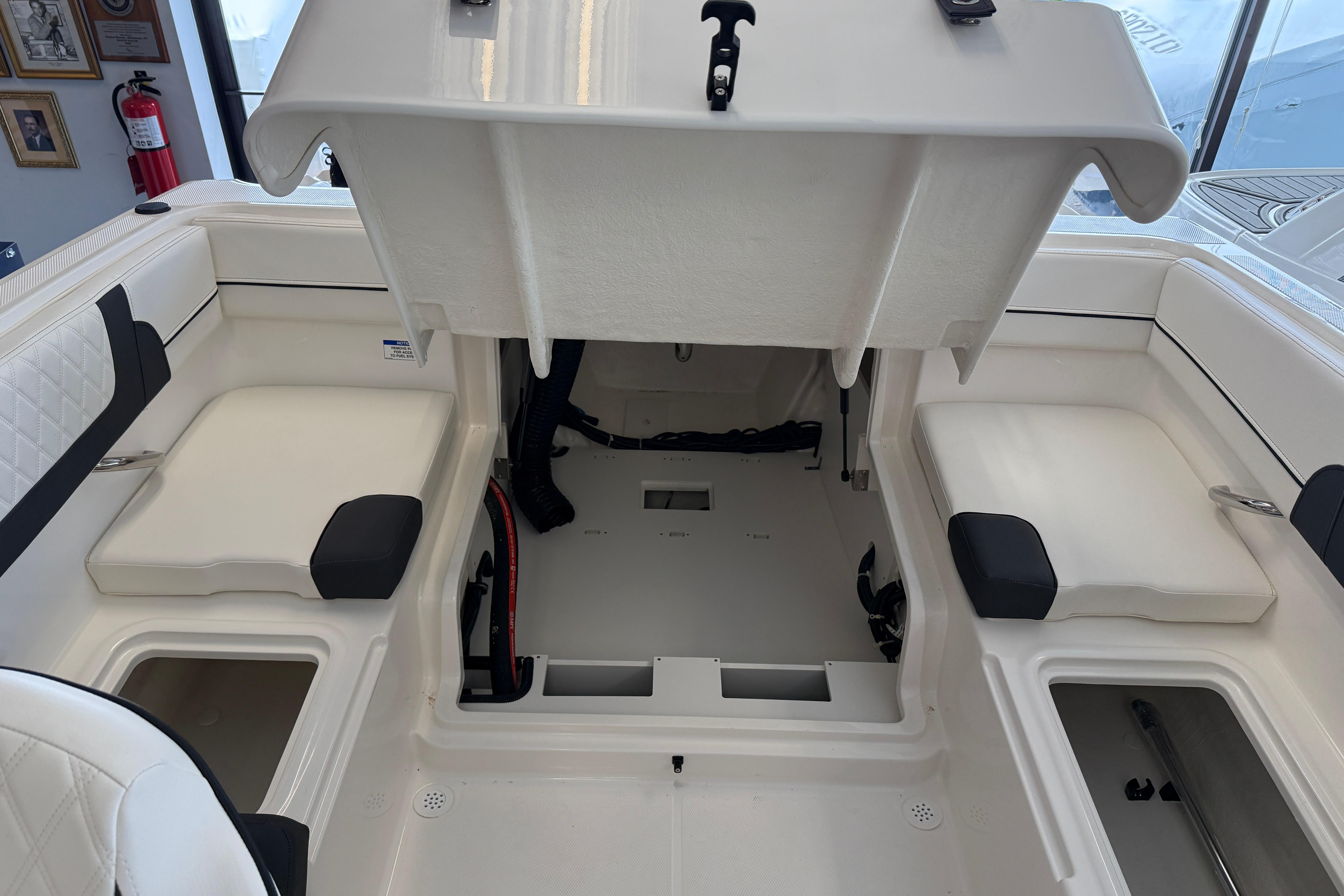 2025 Bayliner VR4 Bowrider OB interior with open storage compartments and seating.