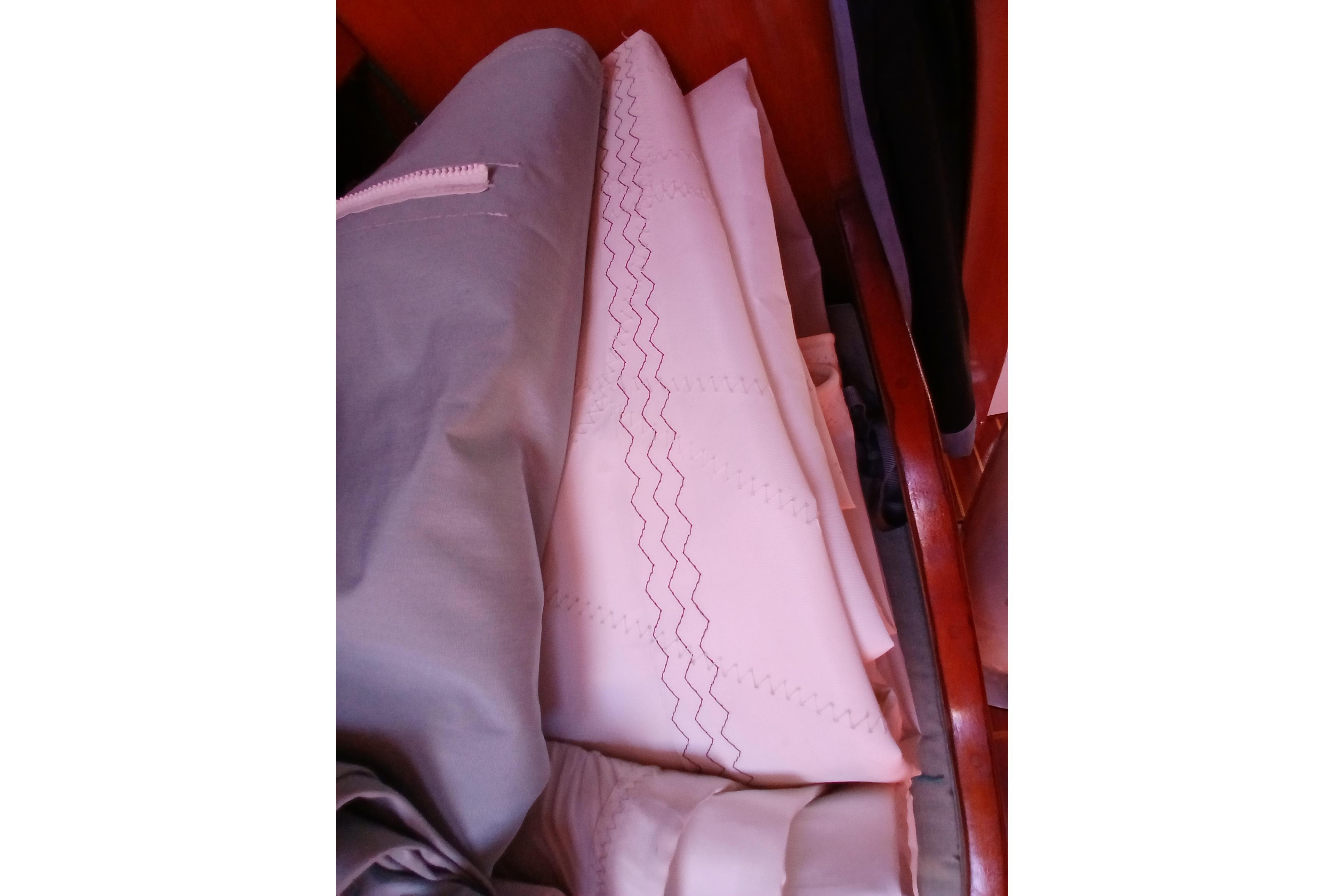 Folded sails inside a 1981 Kaufman Skye 51 yacht, showcasing intricate stitching.