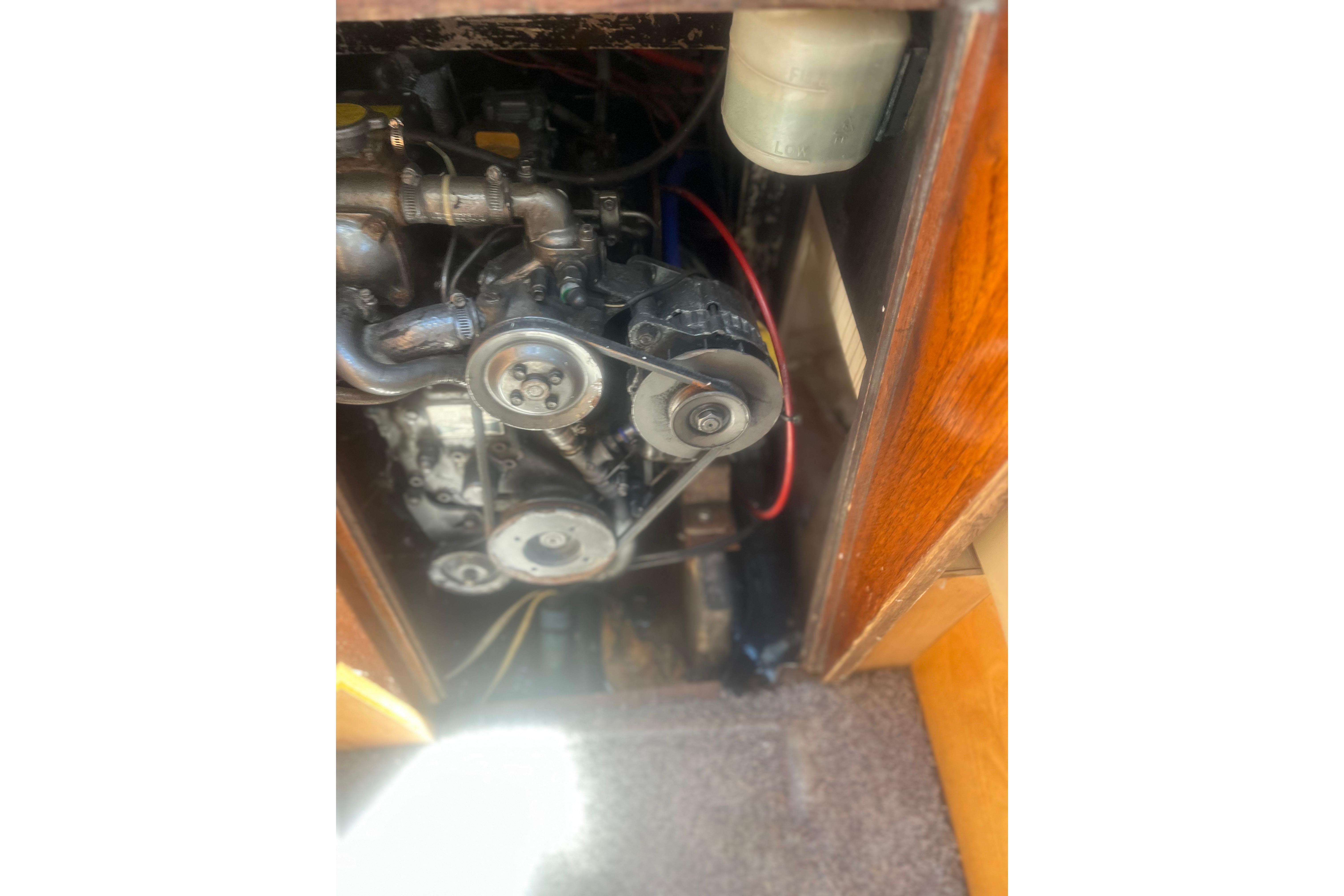 Engine compartment of a 1972 C&C 30 sailboat, showing belts and pulleys.