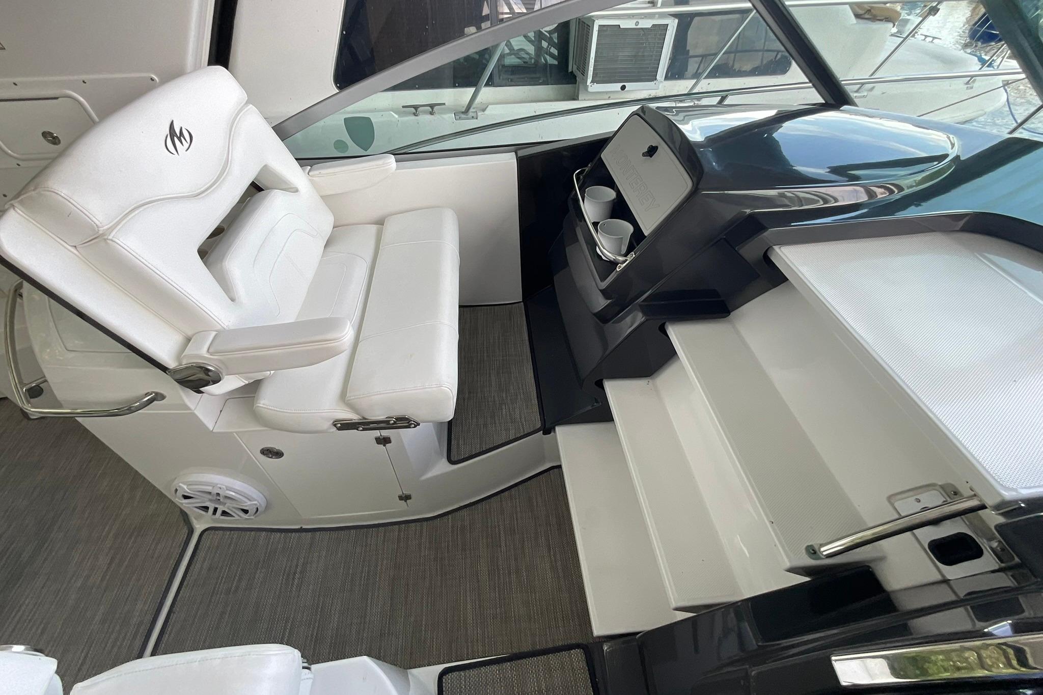 Cockpit of 2019 Monterey 335 Sport Yacht with white seating and helm station.