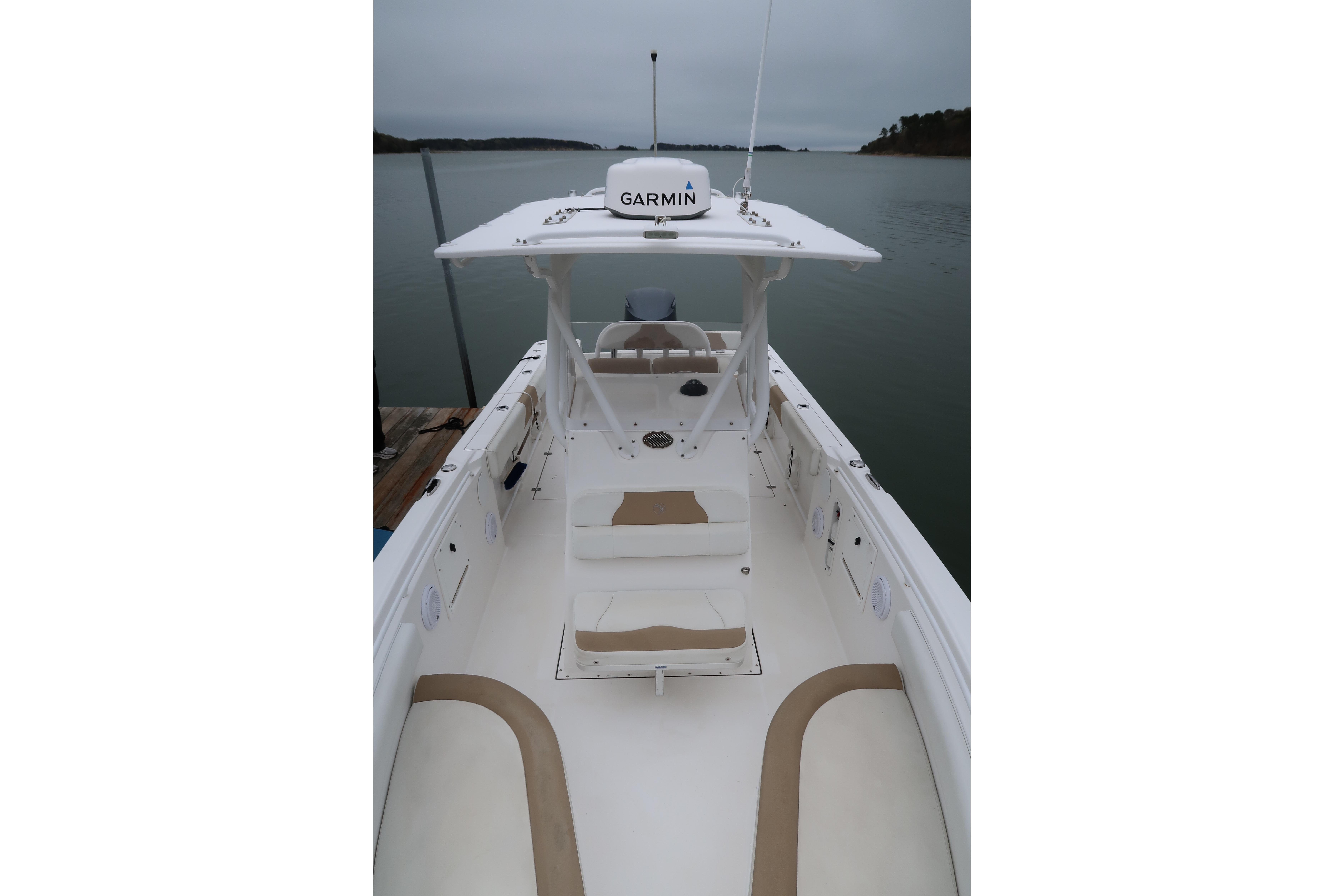 2017 Edgewater 245CC boat with Garmin equipment, docked on a calm lake.