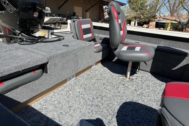 2026 Ranger VS1882SC Reata boat interior with gray and red seating and carpeted flooring.