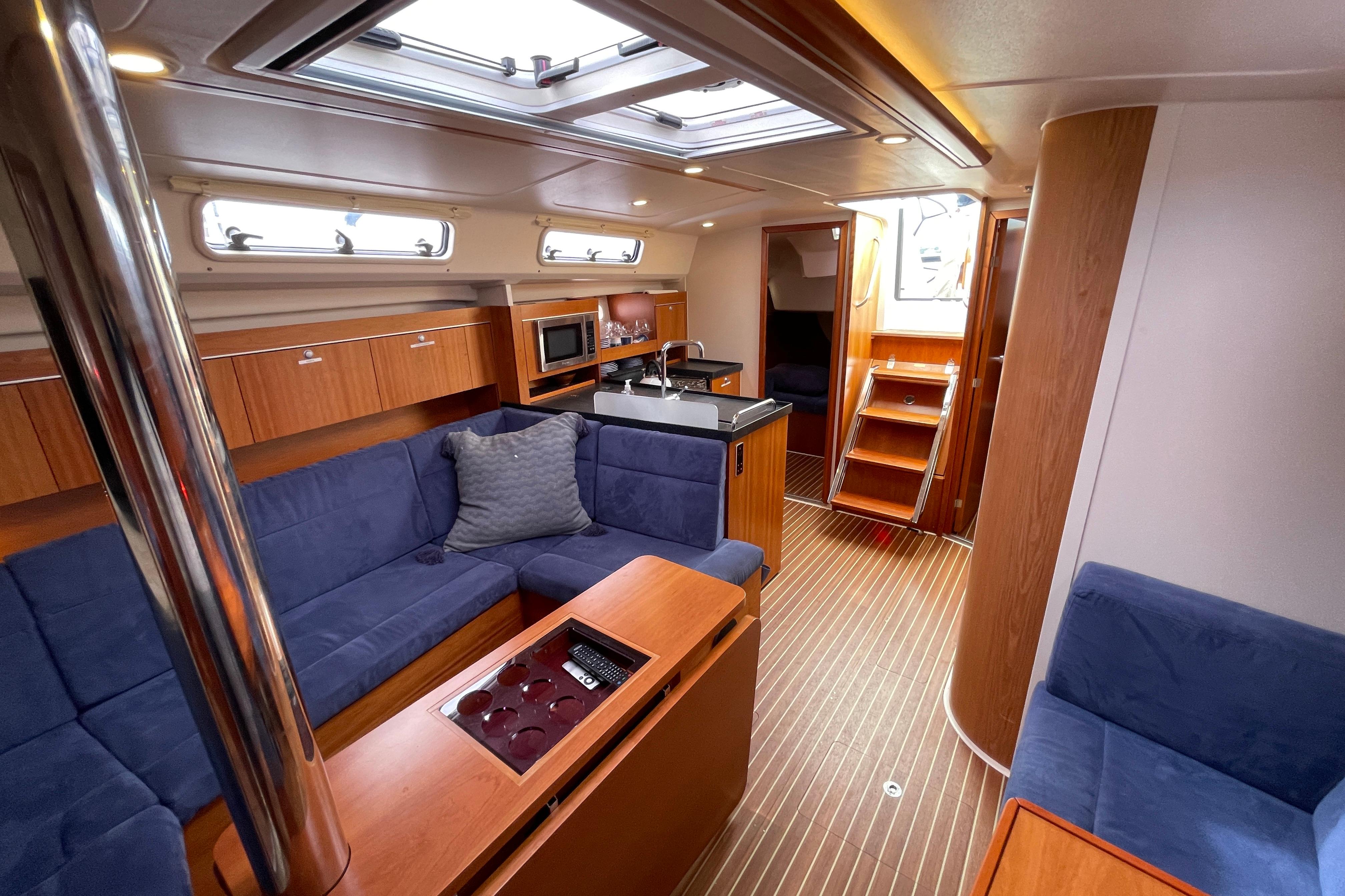 Interior of 2014 Hanse 415 yacht with modern kitchen and cozy seating area.