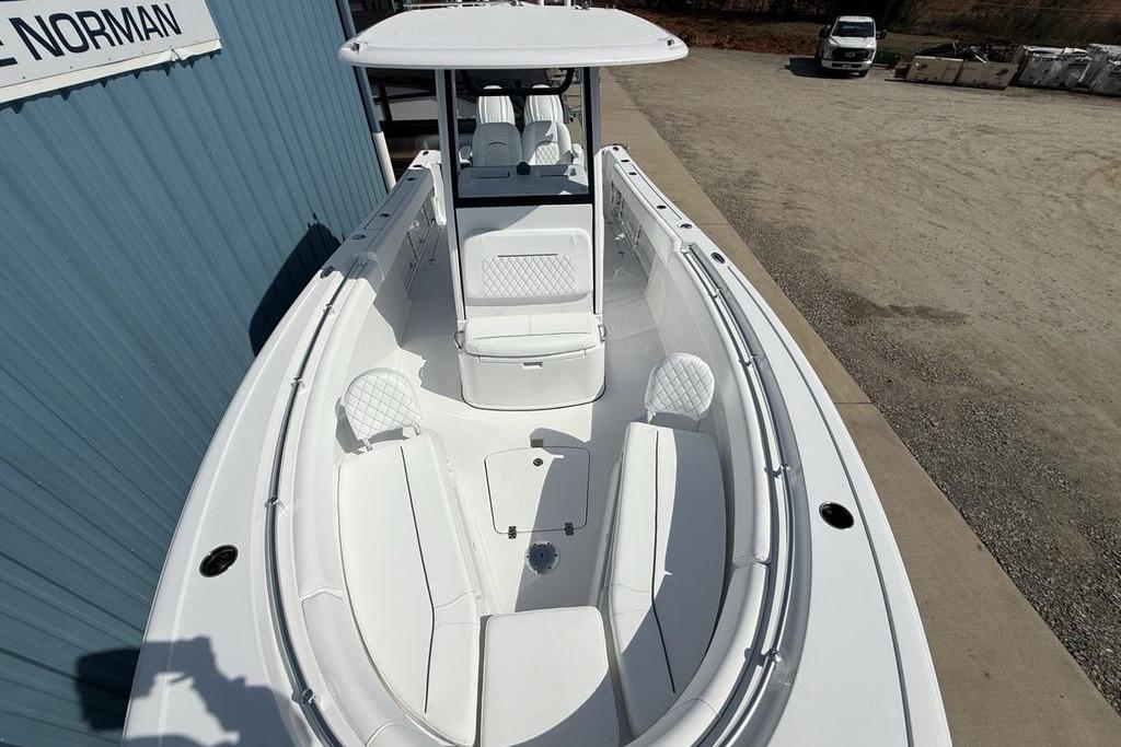 2026 Sportsman Open 252 Center Console boat with sleek white seating and modern design.