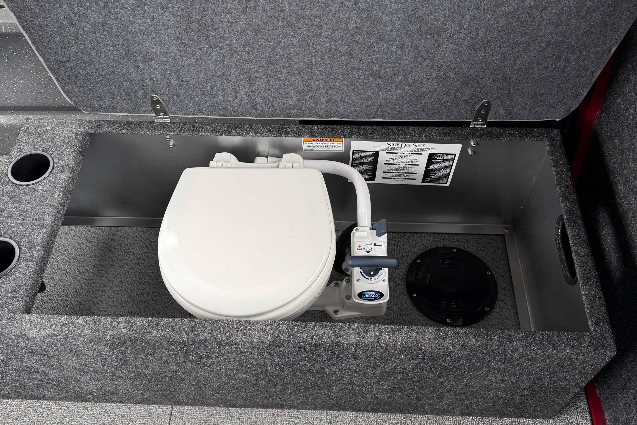 Built-in toilet in 2024 Spartan 24 MAXIMUS PRO XL boat, featuring Jabsco marine pump.