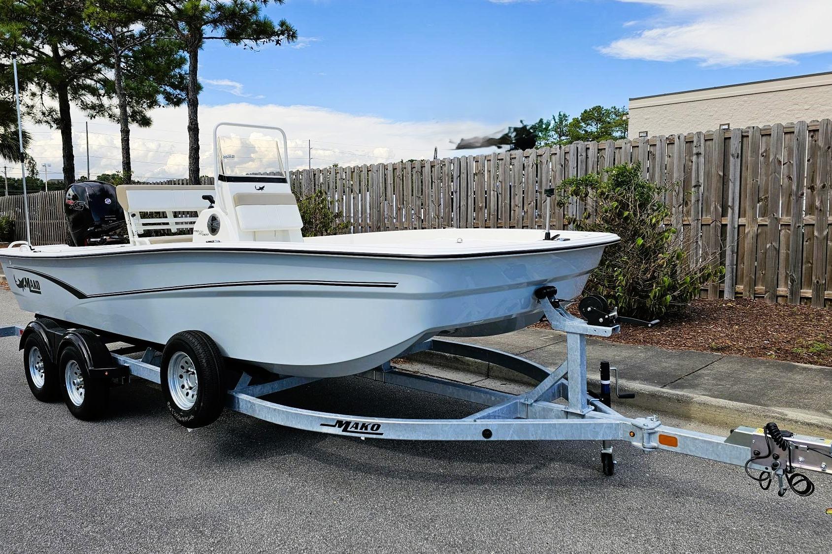 2026 Mako Pro Skiff 19 CC boat on trailer, parked outdoors.