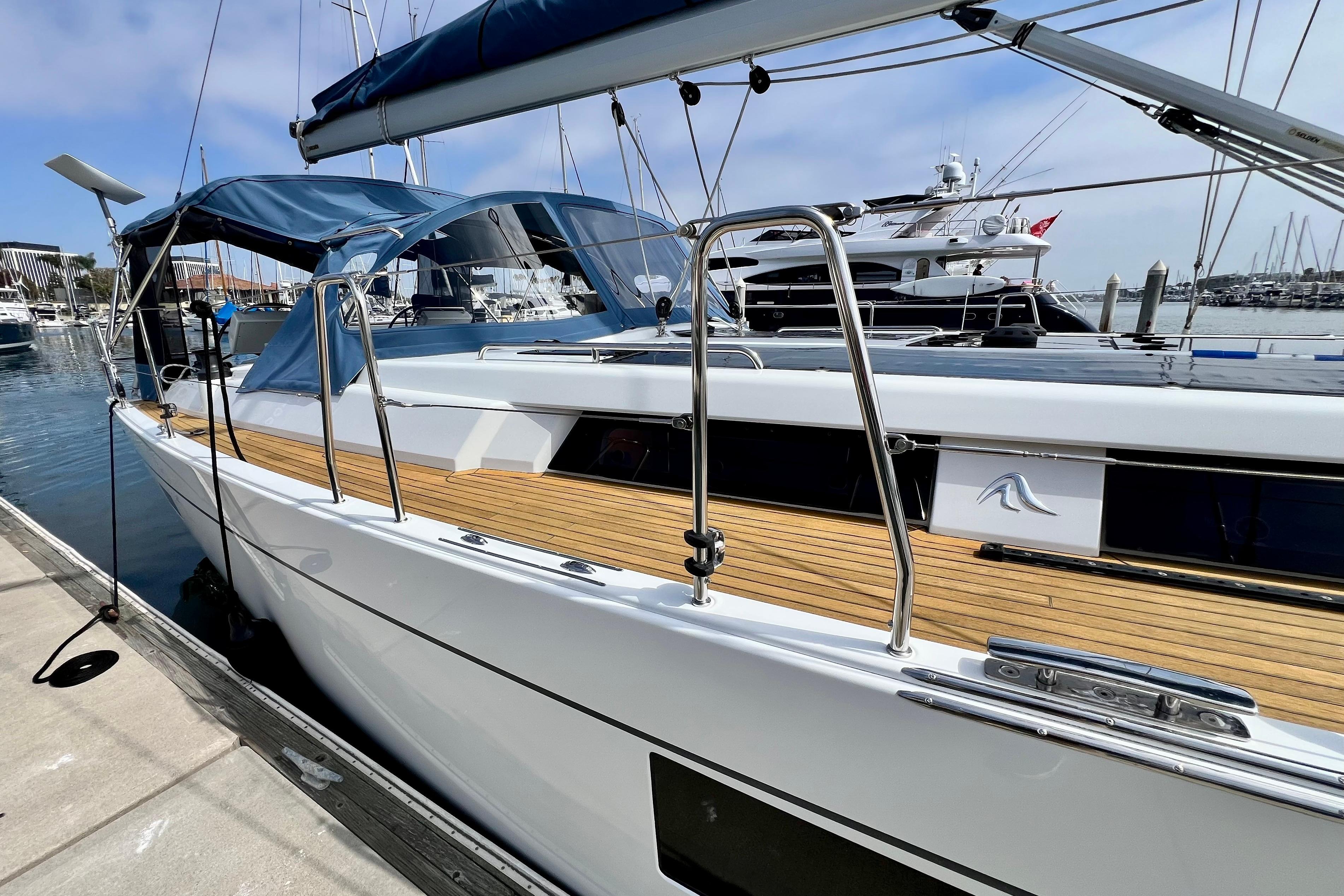 2016 Hanse 455 yacht docked at marina, featuring sleek design and wooden deck.