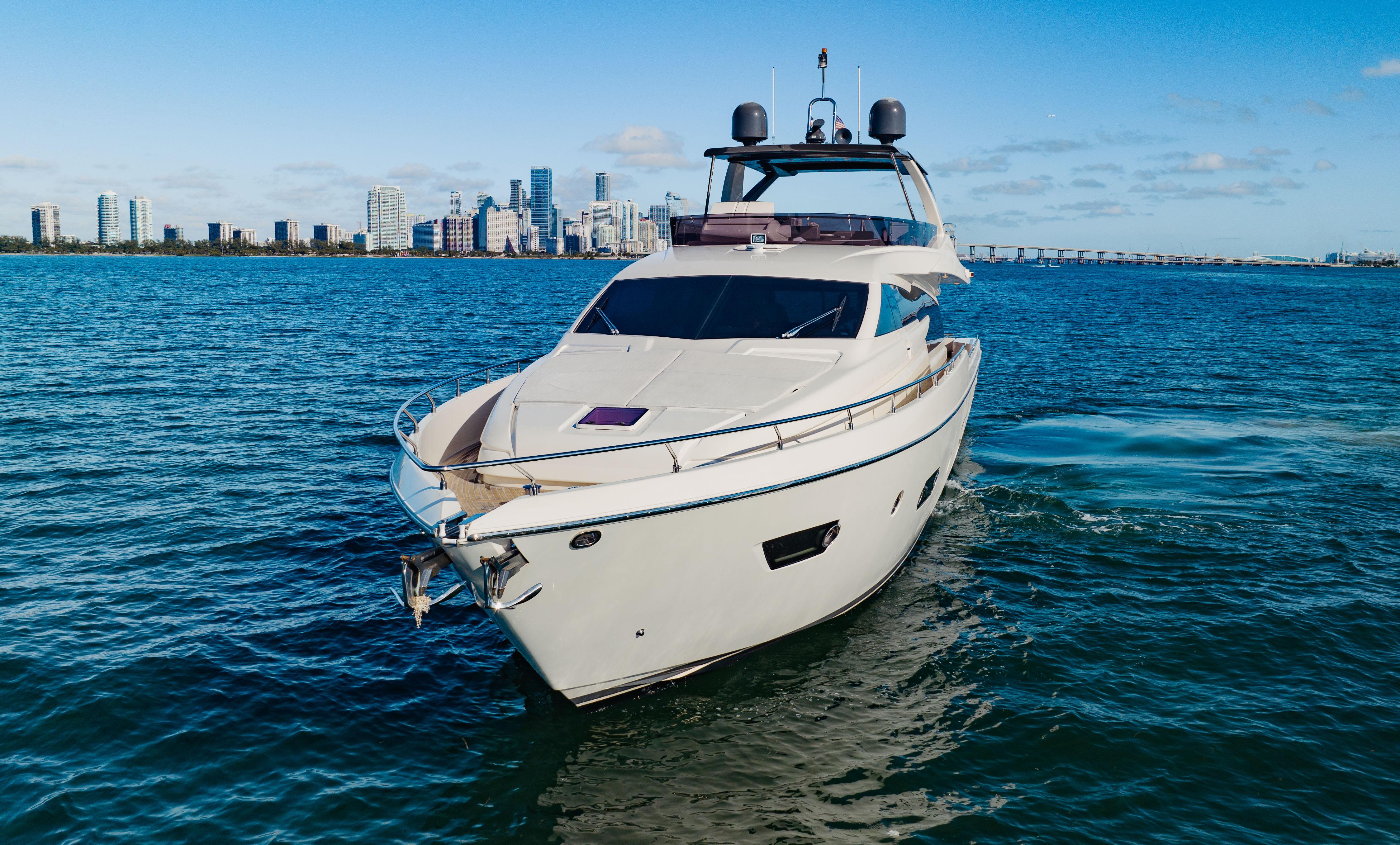 Luxurious 2017 Ferretti Yachts 750 cruising near city skyline on a sunny day.