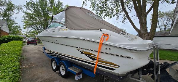 1999 Sea Ray 280 SS boat on trailer, covered and parked in driveway.