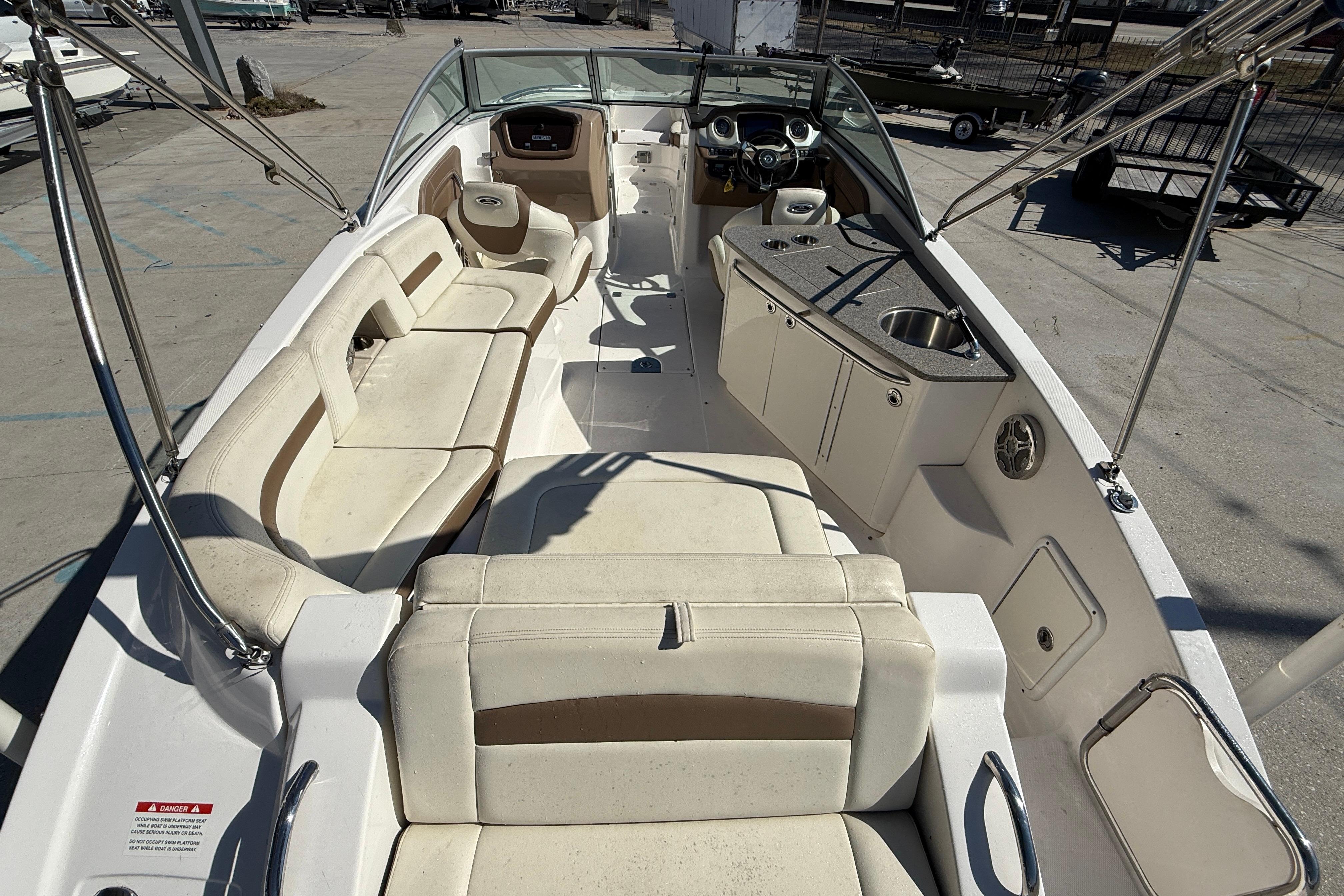 2014 Chaparral 264 Sunesta boat interior with seating and kitchenette.
