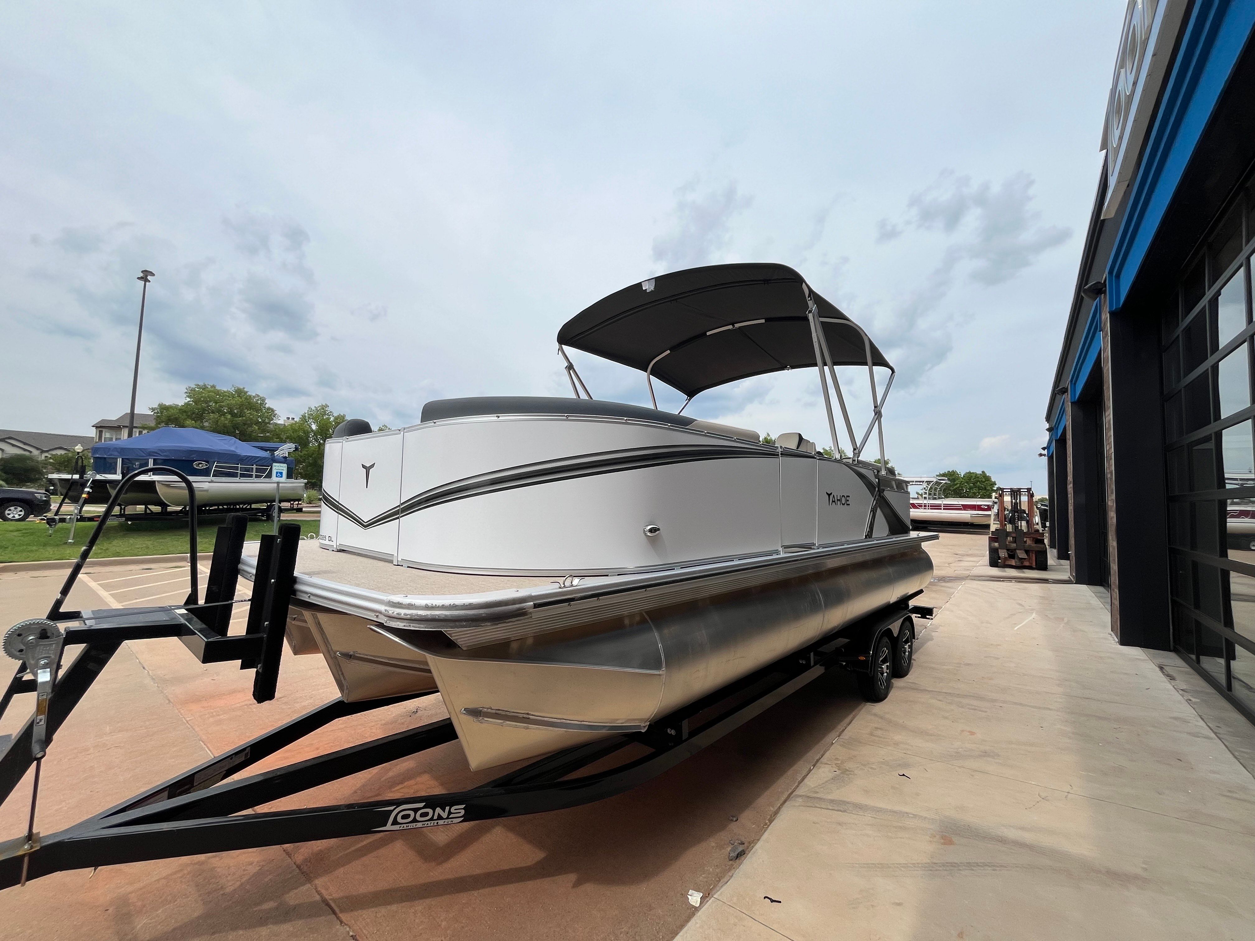2025 Tahoe LTZ QL pontoon boat on trailer outdoors.