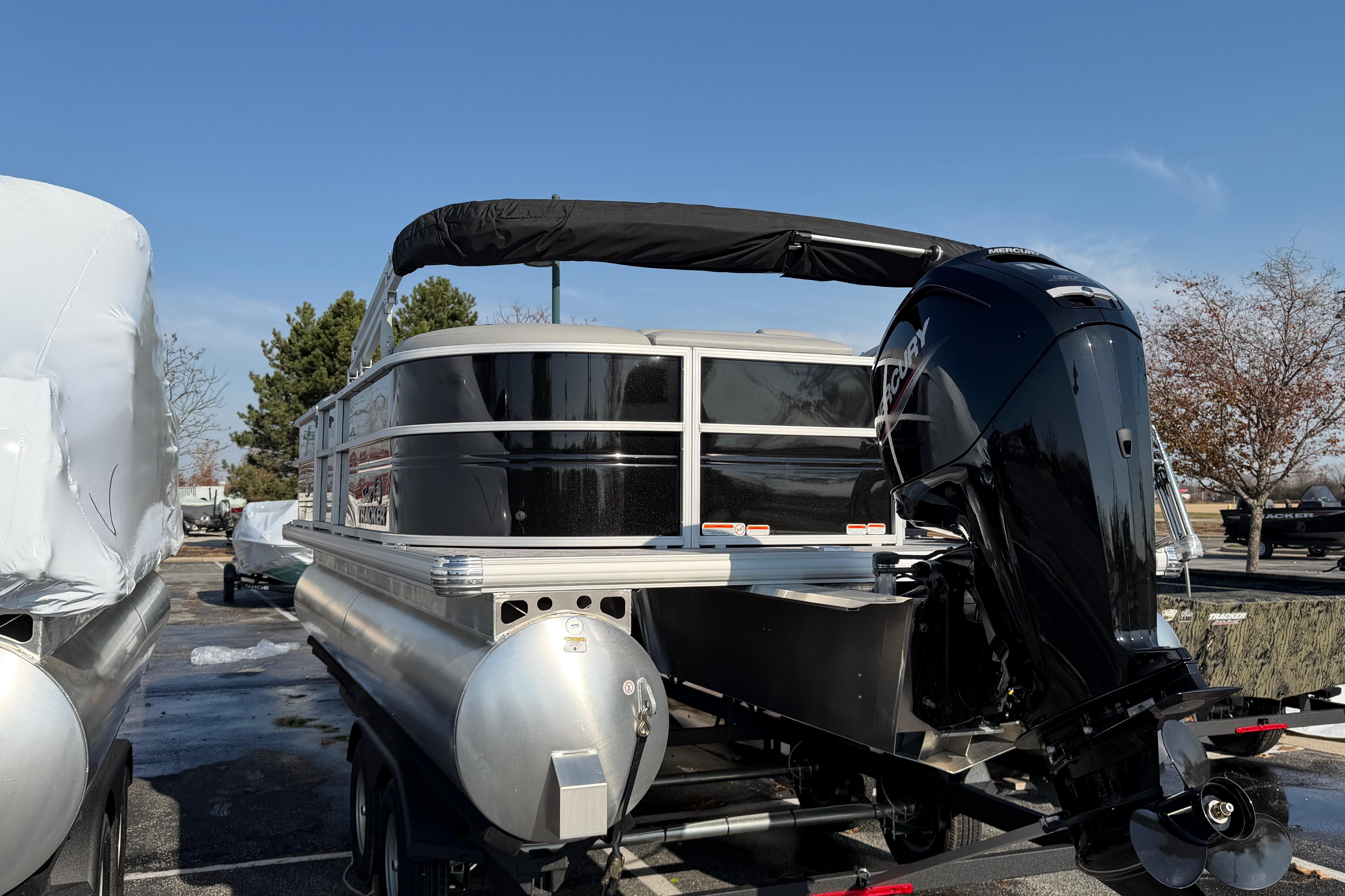2026 Sun Tracker Party Barge 20 DLX pontoon boat with Mercury outboard motor.