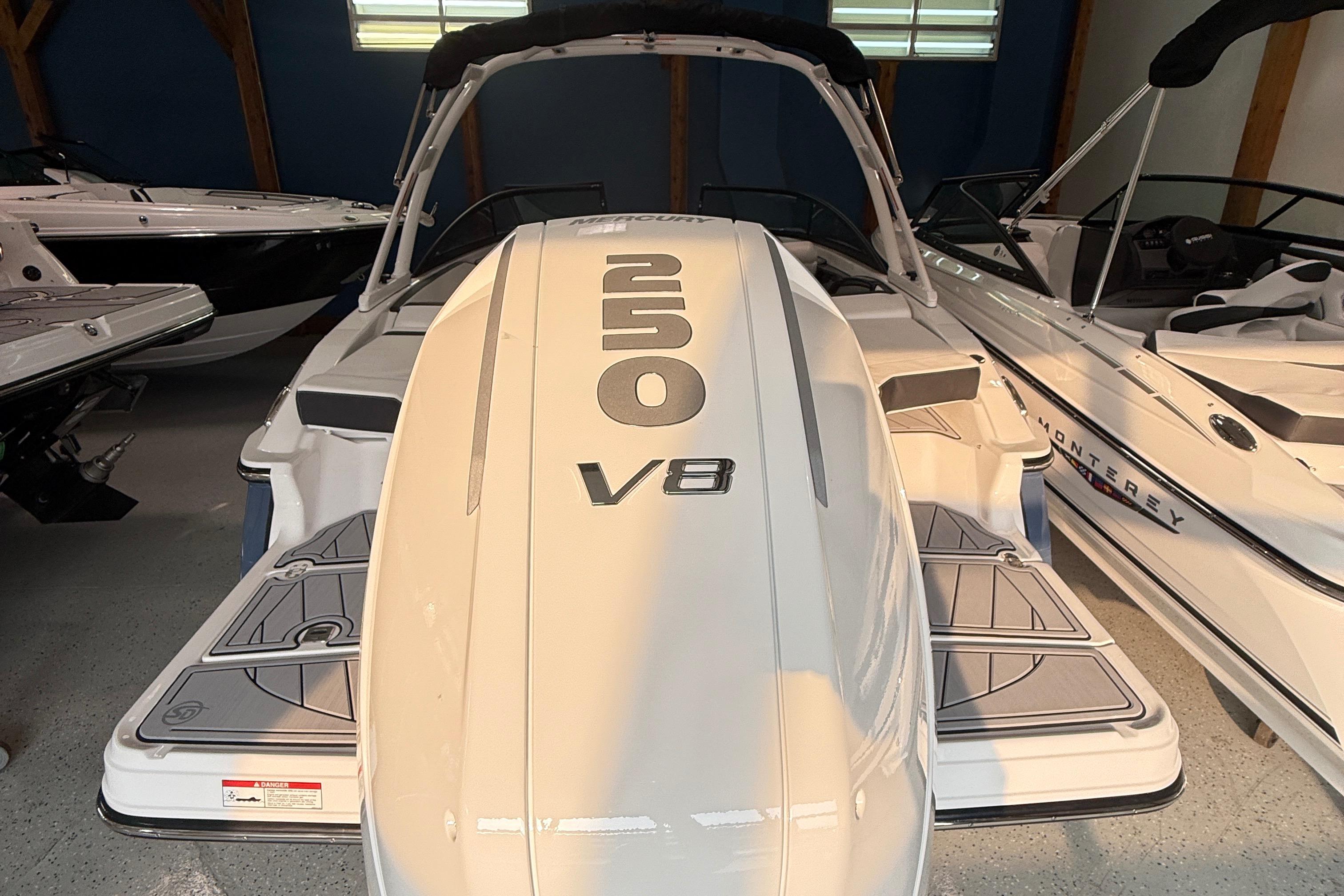2025 Monterey 235SS Super Sport boat with V8 engine, displayed indoors.
