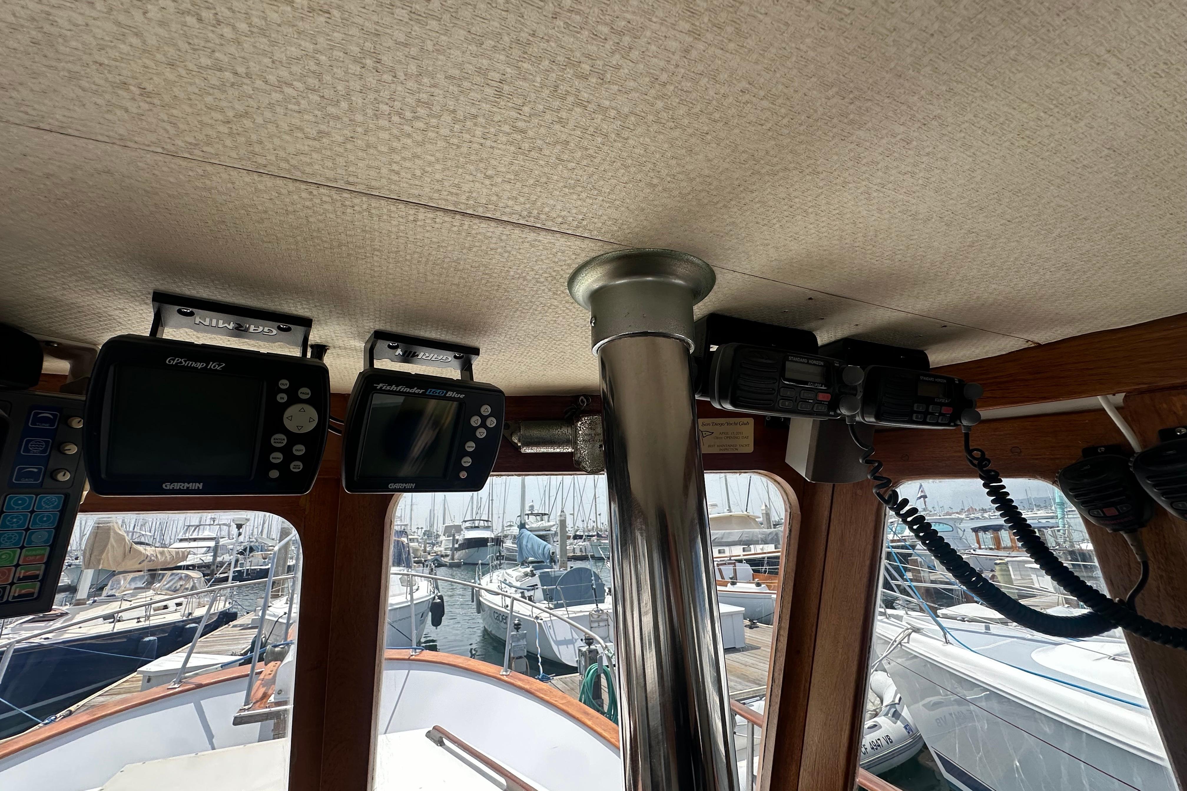 Interior of a 1973 CHB 33 boat with navigation equipment and marina view.