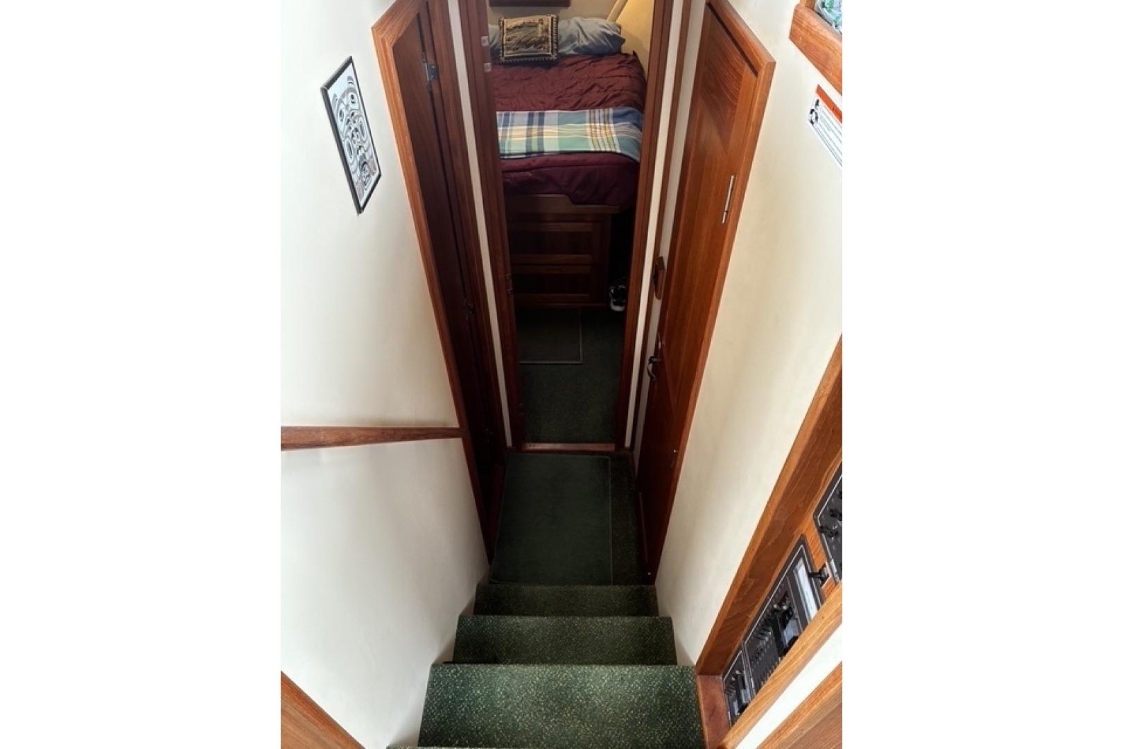Stairway leading to cozy cabin interior of 2000 Nordic Tug 37 boat.