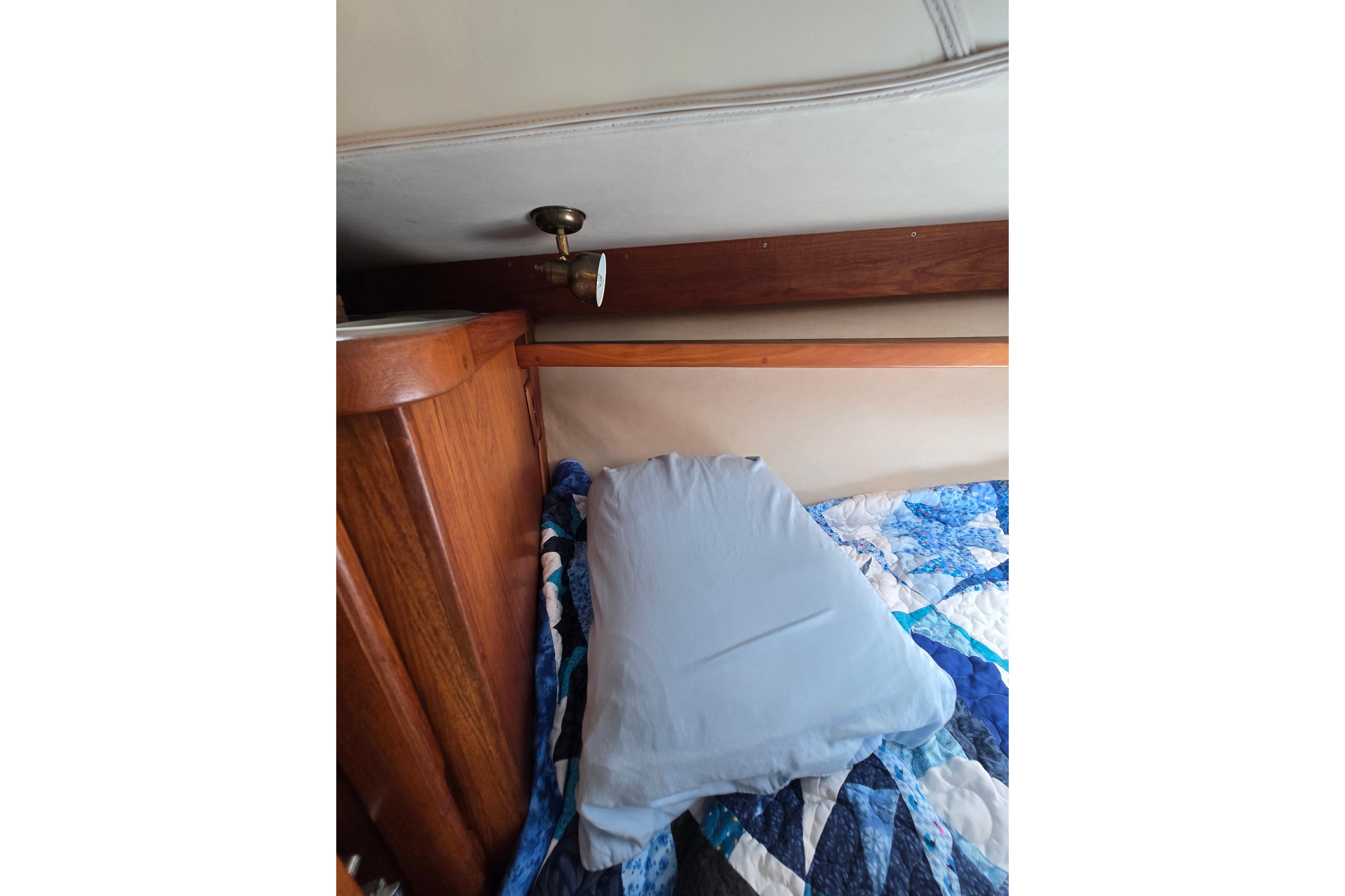 Cozy cabin interior of 1993 Caliber 35 sailboat with quilted bedding.