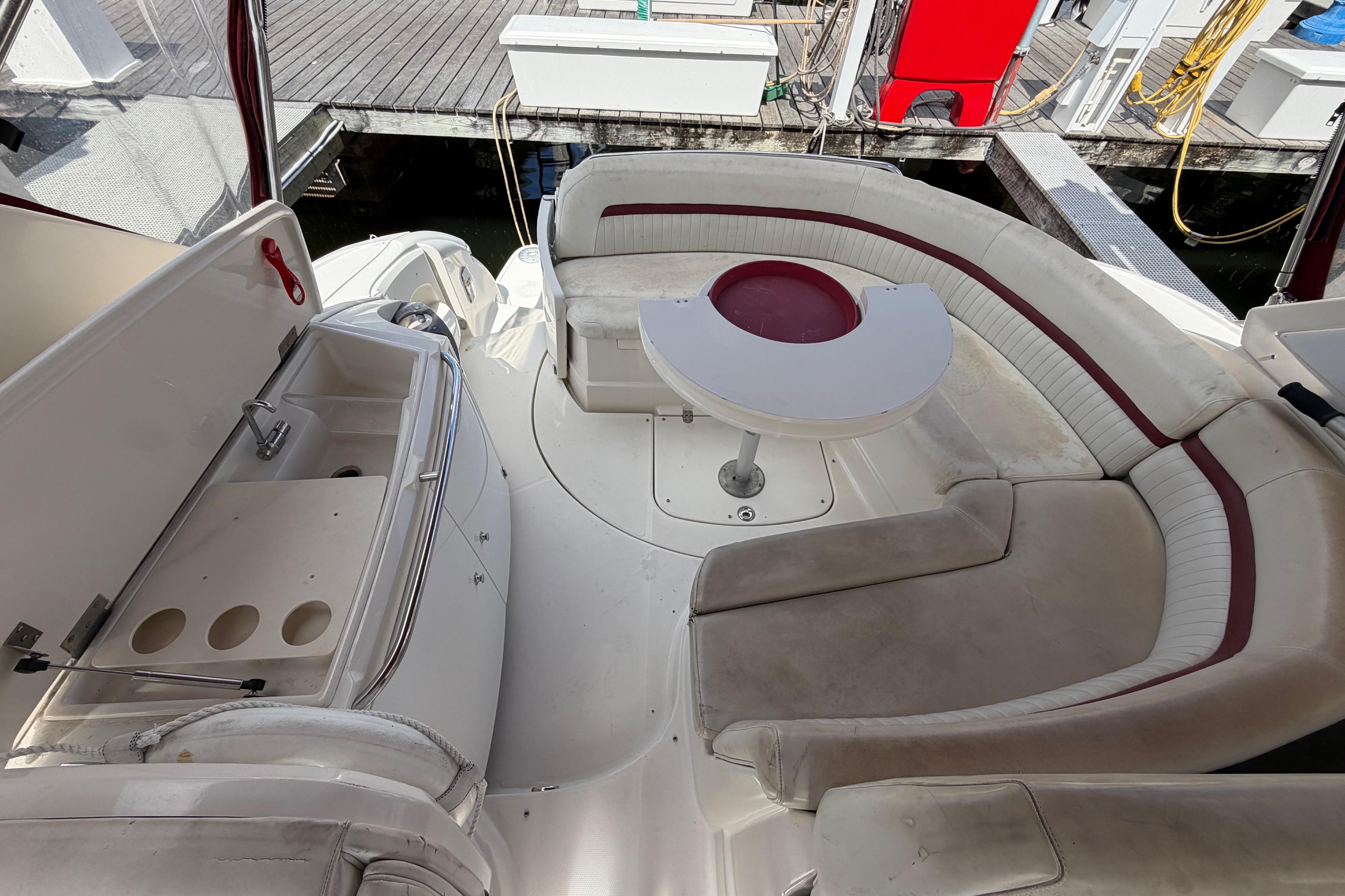 2007 Monterey 350 Sport Yacht interior with curved seating and compact kitchenette.