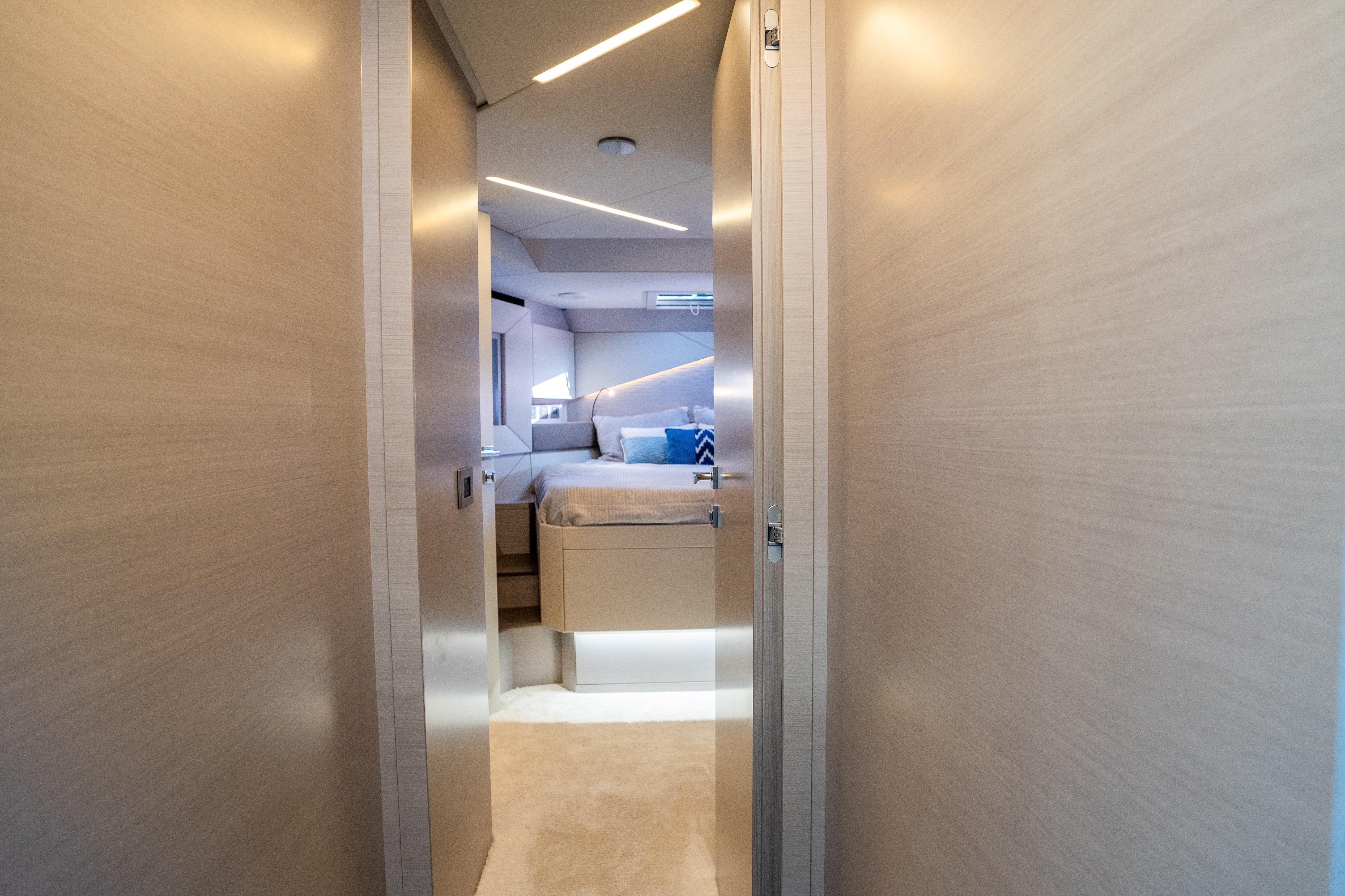 Luxurious interior of 2024 Pershing 7X yacht, featuring modern bedroom design.
