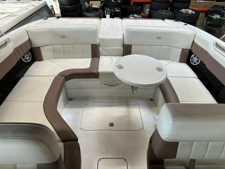 Luxurious seating area on a 2011 Cobalt 296 boat with white and brown upholstery.