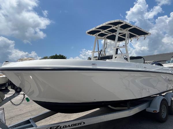 2022 Bayliner Trophy T22CC boat on trailer under a cloudy sky.