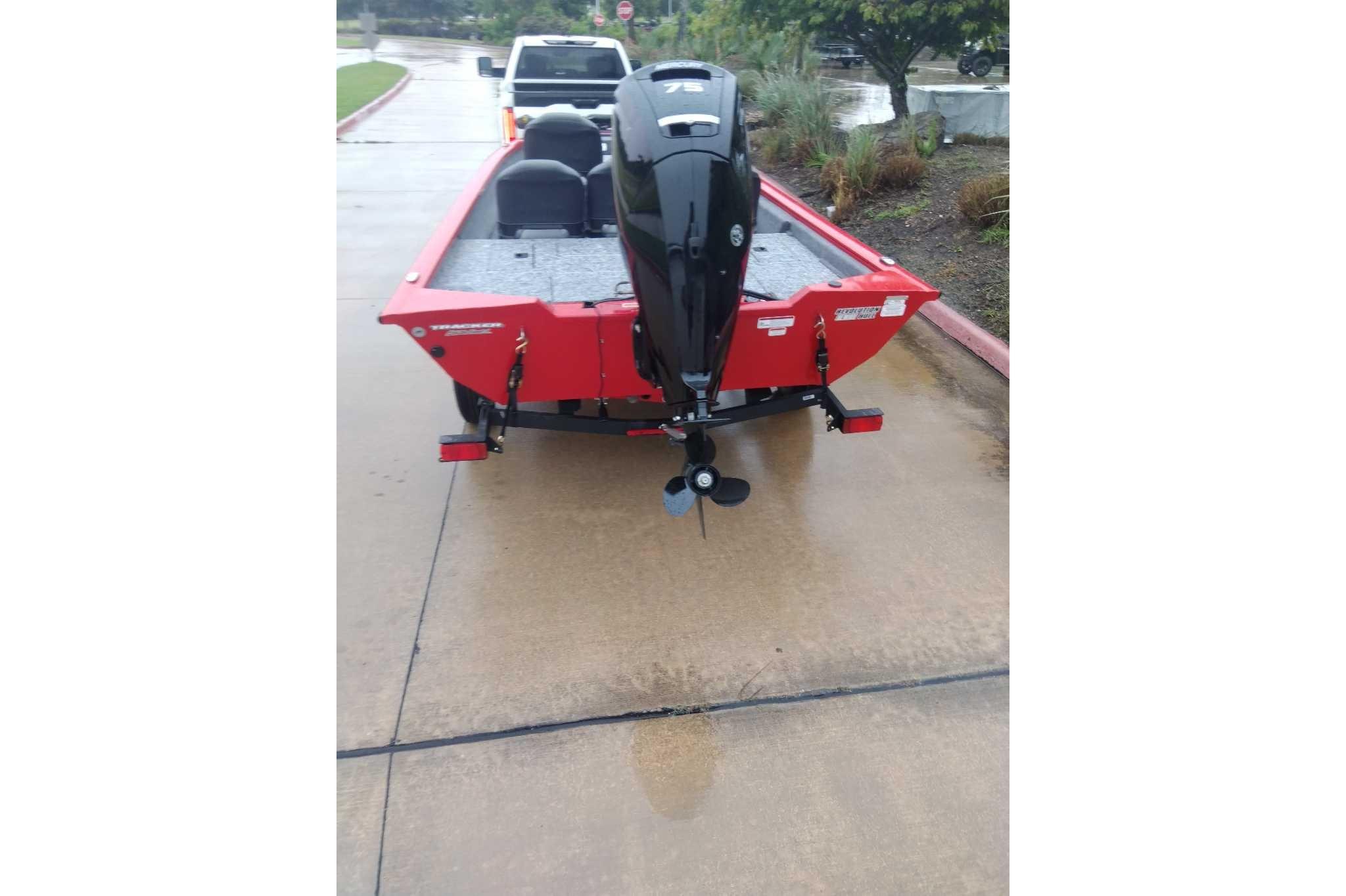 2026 Tracker Pro Team 175 Crappie Edition boat on wet pavement, rear view.