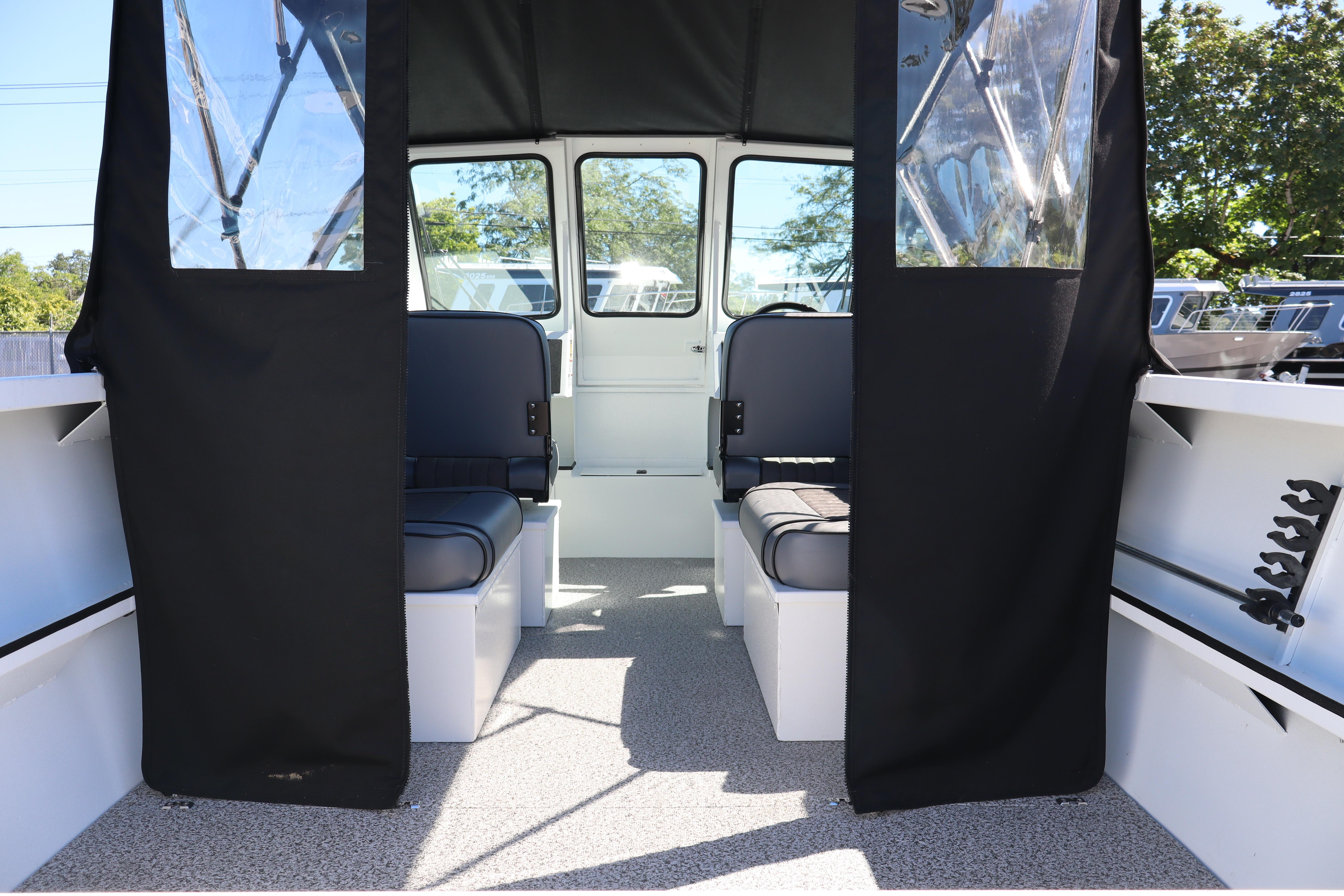 Interior view of 2026 Alumaweld Stryker 202 boat with seating and canopy.