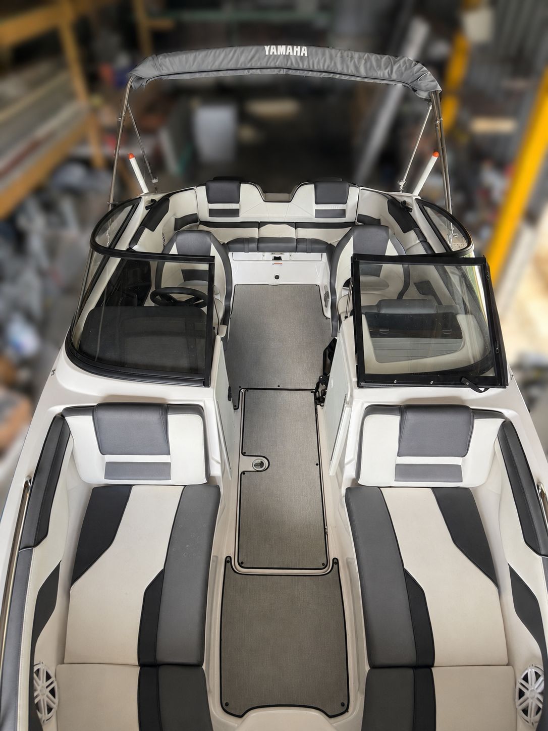 The image shows the deck of a 2021 Yamaha SX210 boat with gray and white seating.